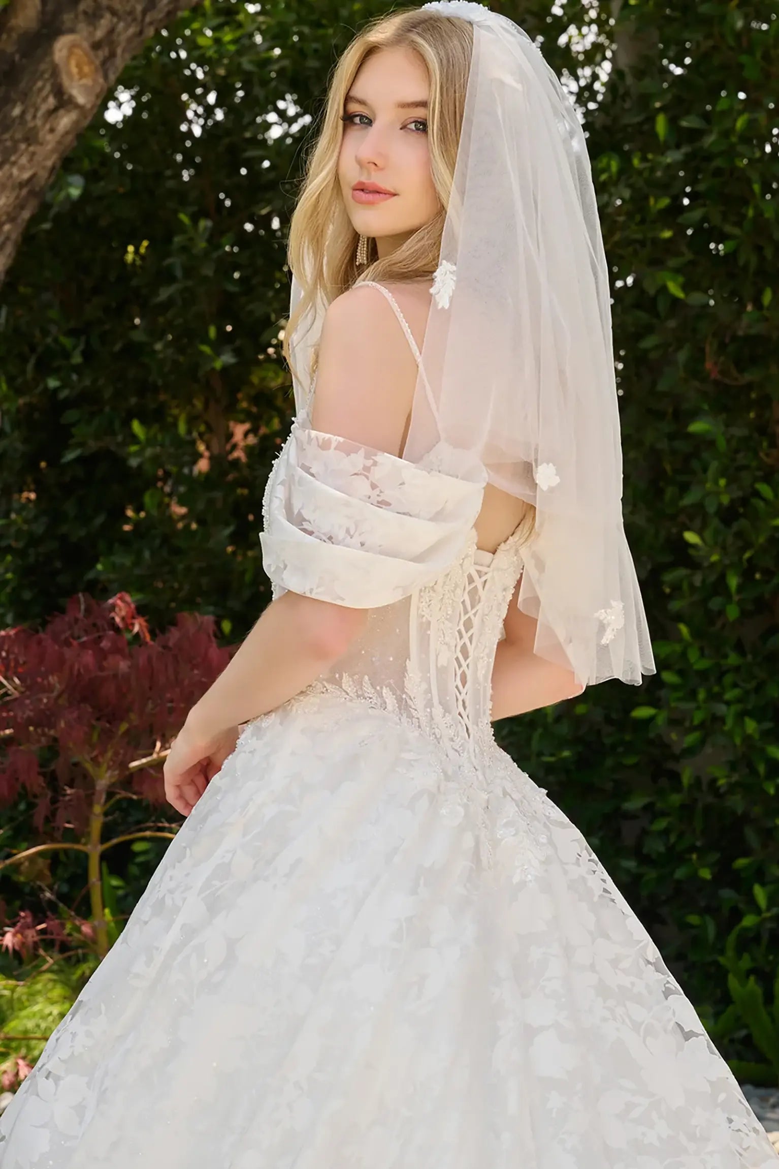 Off-white wedding dress crafted with organza jacquard sleeves and skirt patterned with floral motifs showcasing floral patterns throughout
