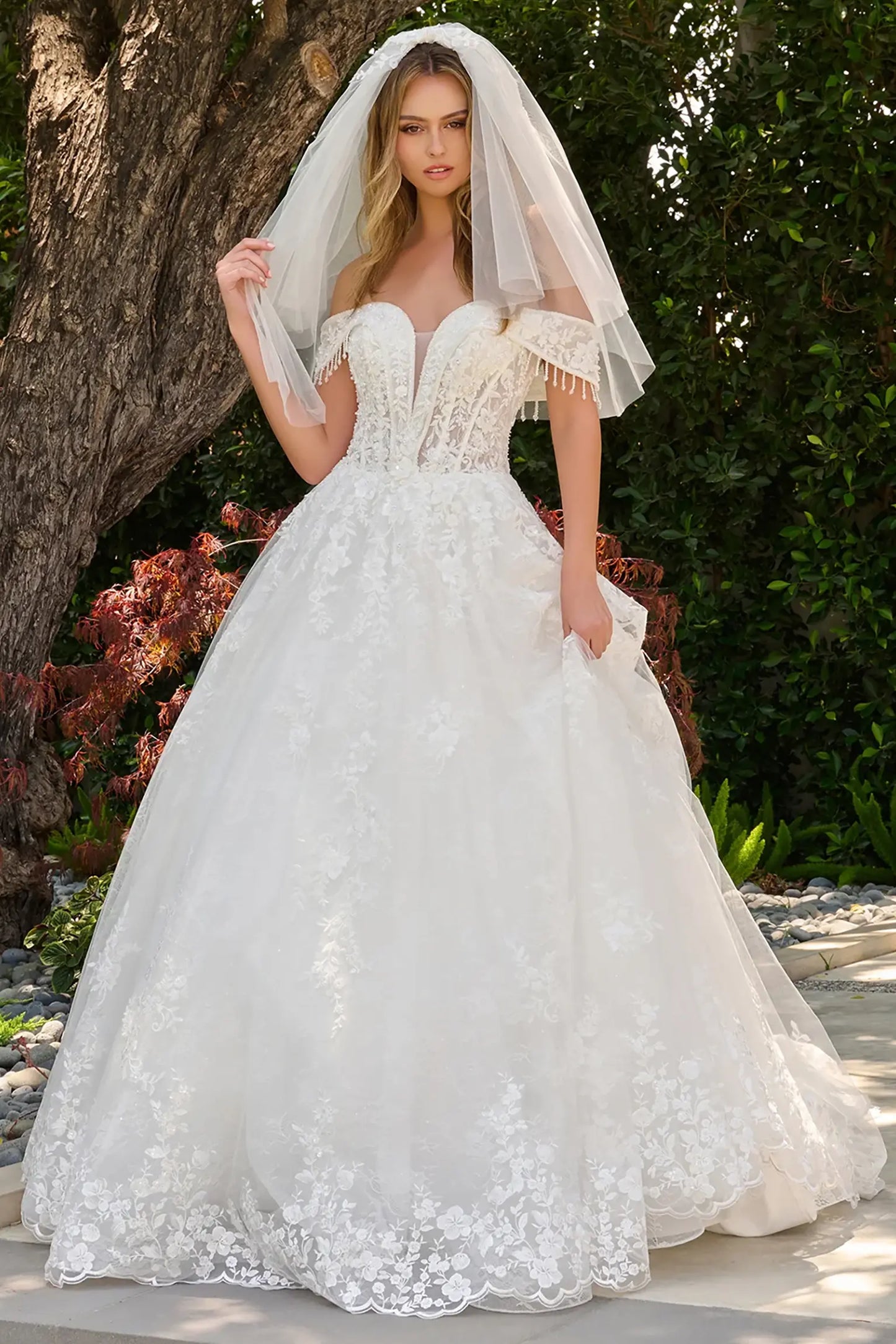 Off-white wedding dress with V-neckline flowing into fold-over off-shoulder straps