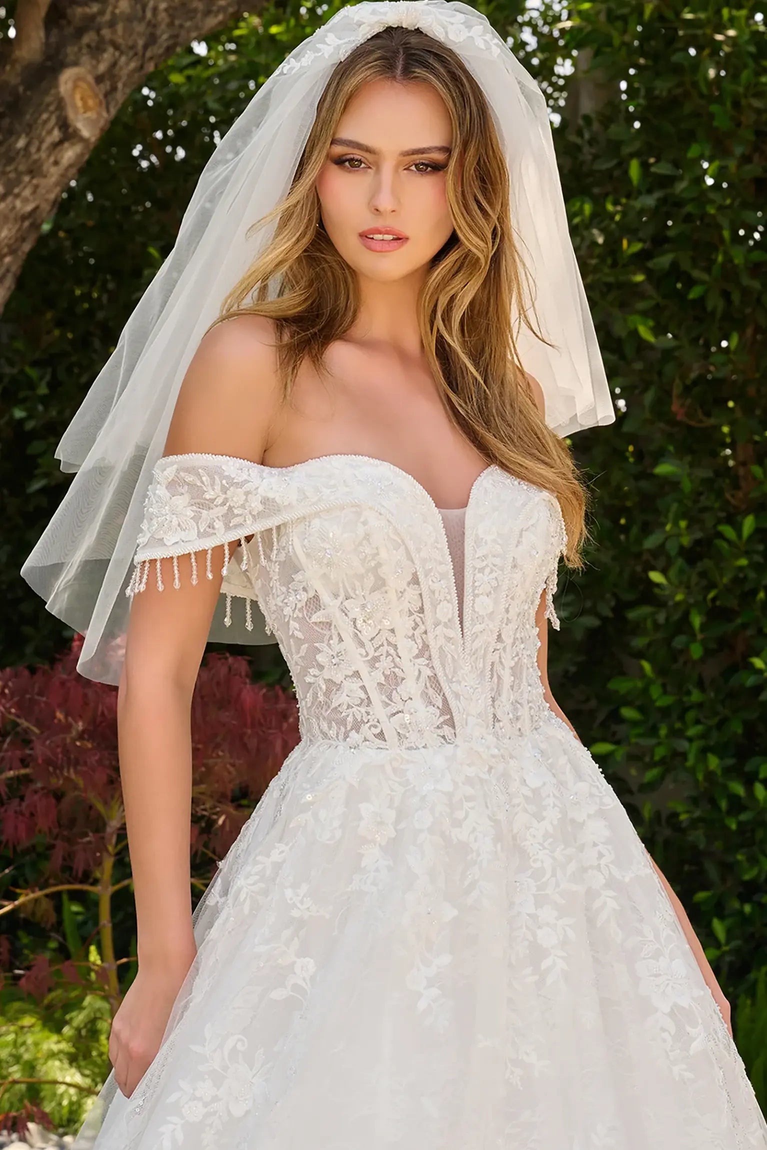 Off-white wedding dress richly adorned with floral embroidery, beads and sequins