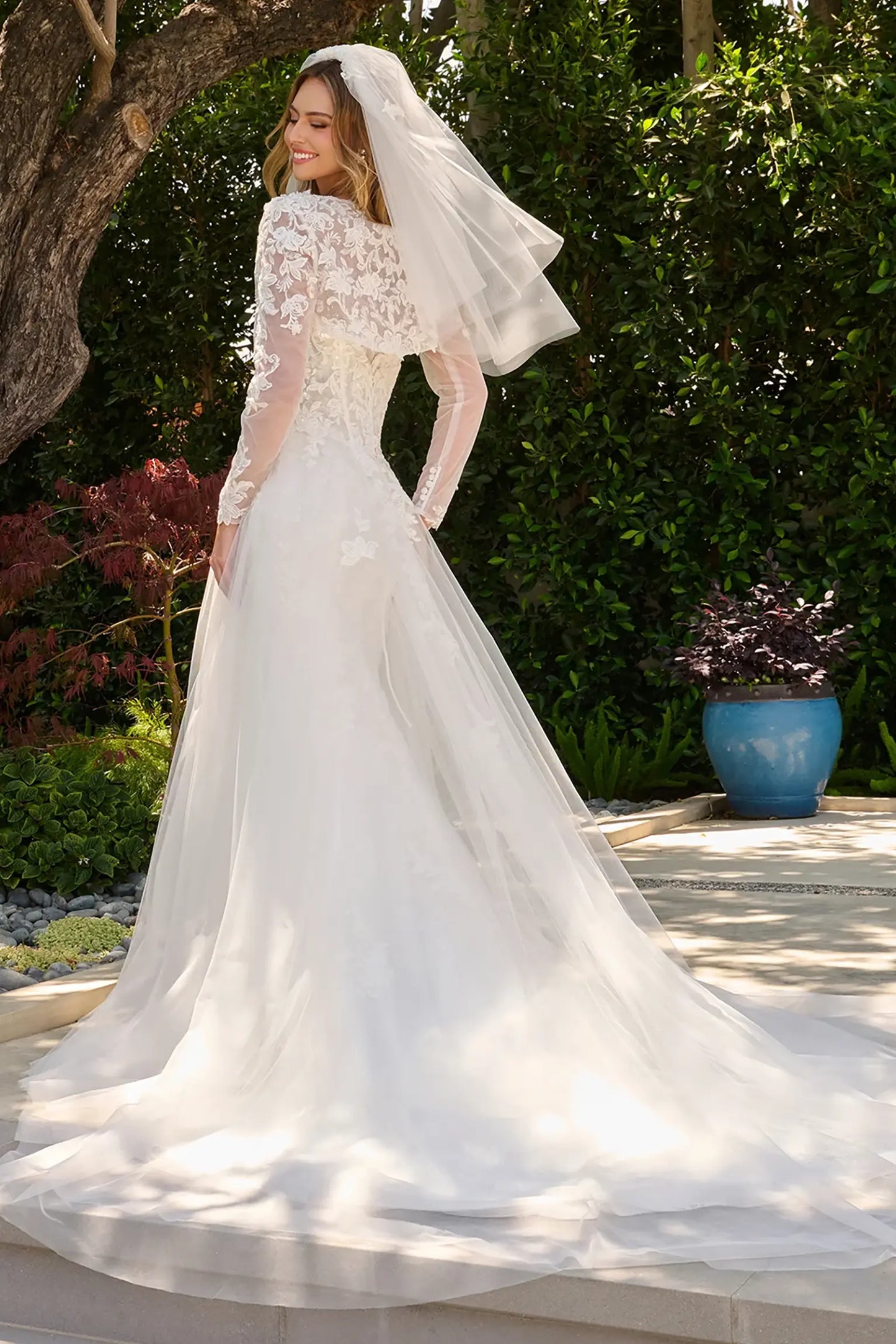Off-white wedding dress styled with bolero shrug finished with dangling bead accents