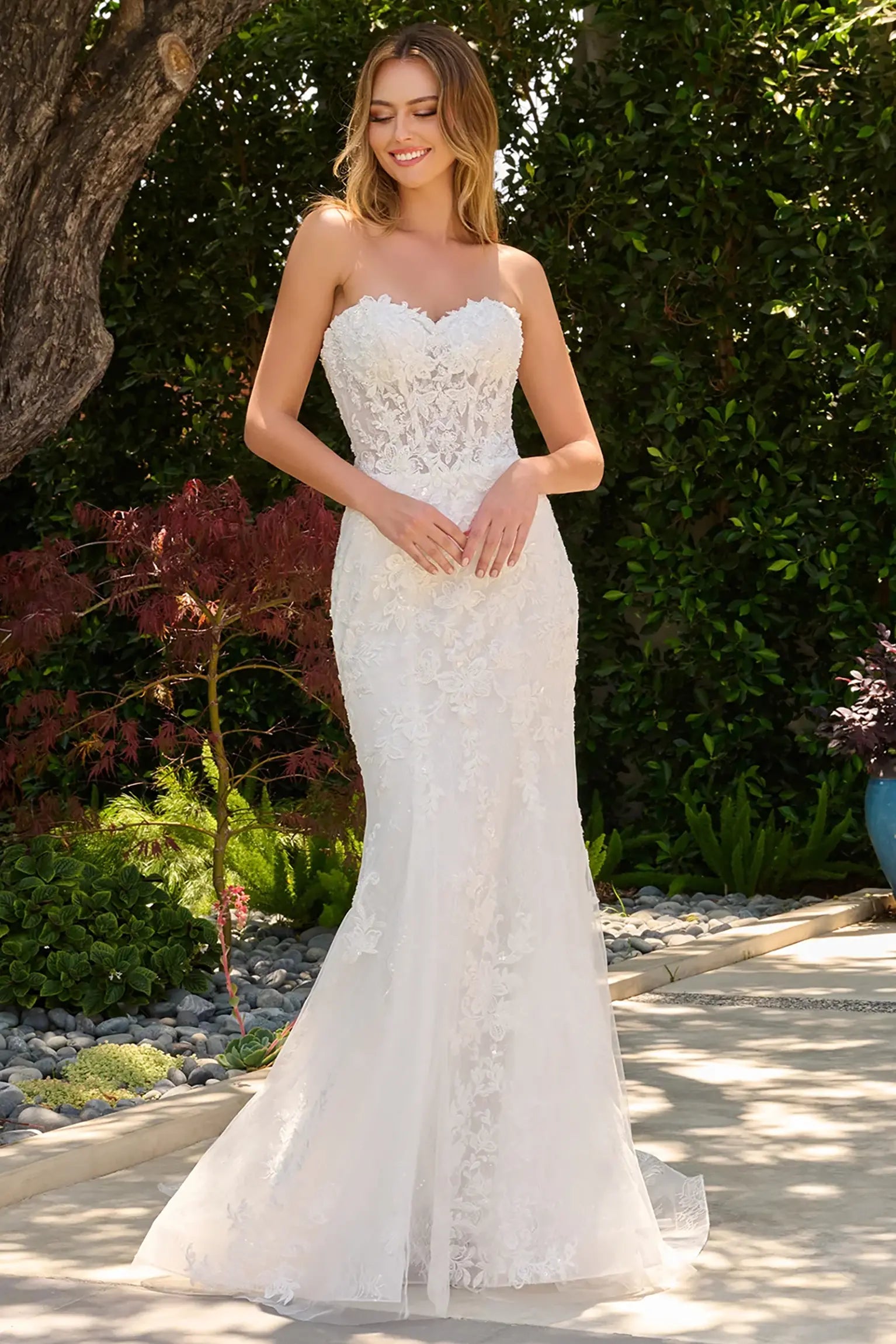 Off-white wedding dress with strapless fitted silhouette and lace underlayer