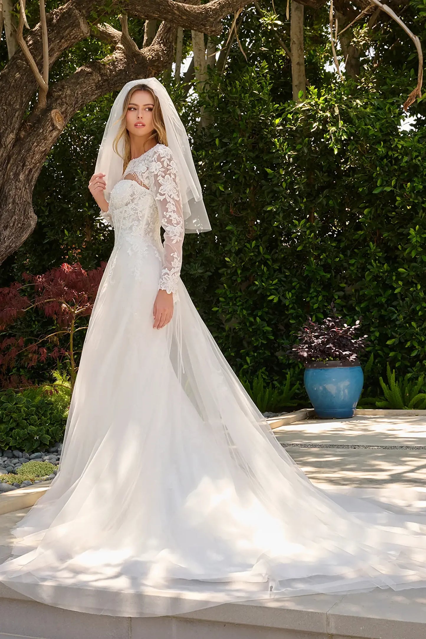 Off-white wedding dress extending into train with cohesive embroidery and beadwork with matching bolero shrug