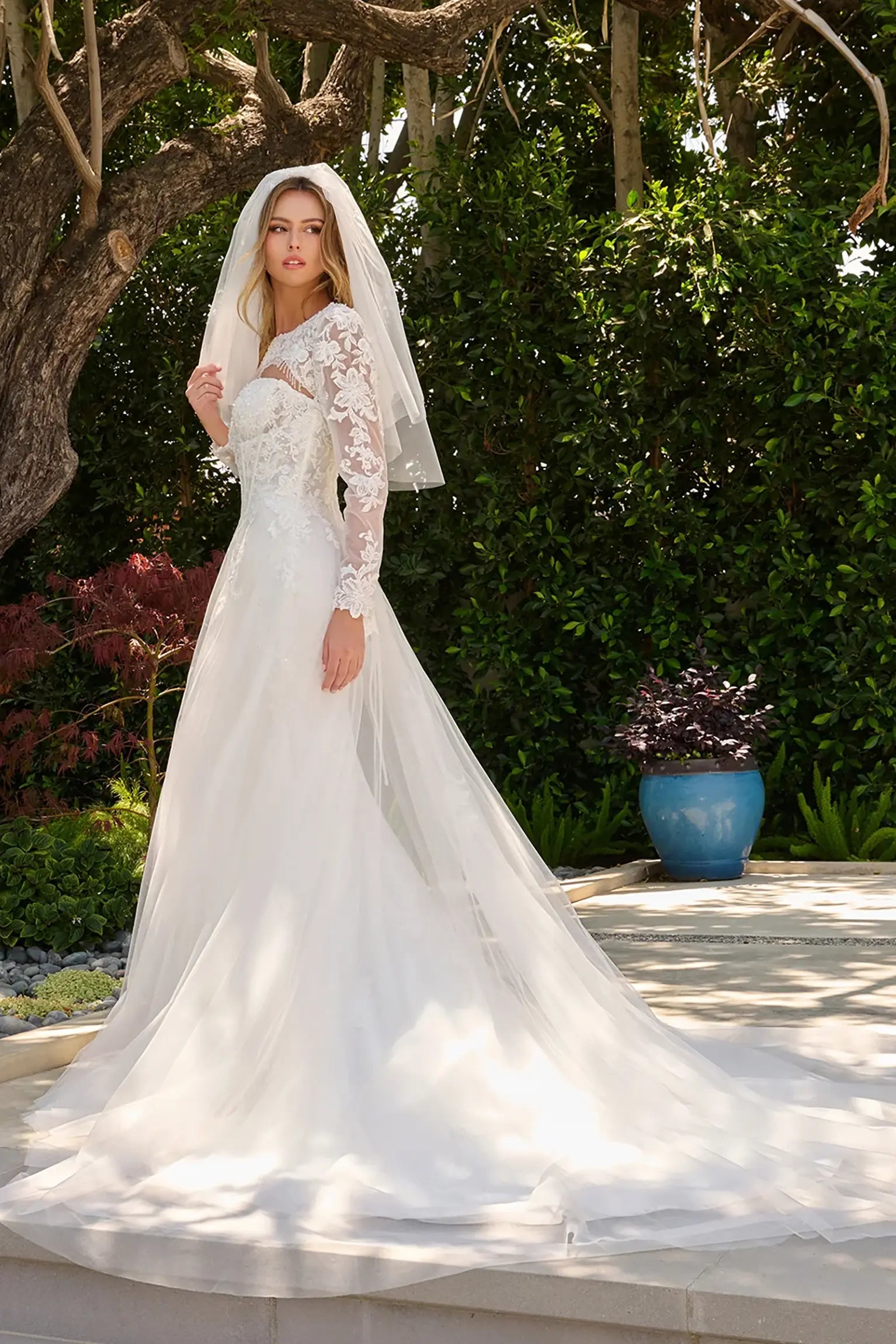 Off-white wedding dress extending into train with cohesive embroidery and beadwork with matching bolero shrug