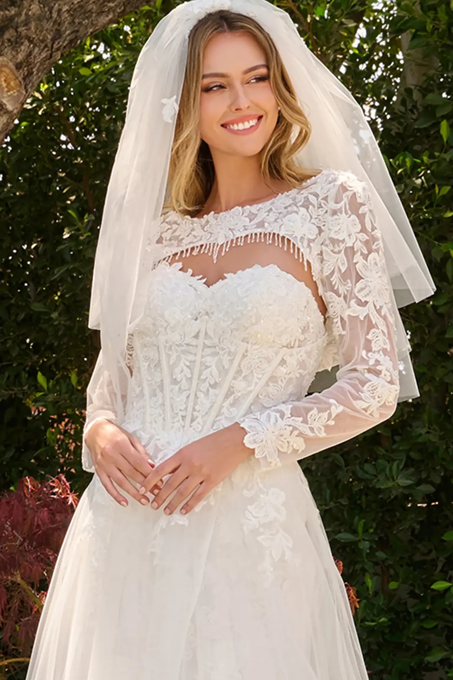 Off-white wedding dress completed with short veil coordinating with the ensemble