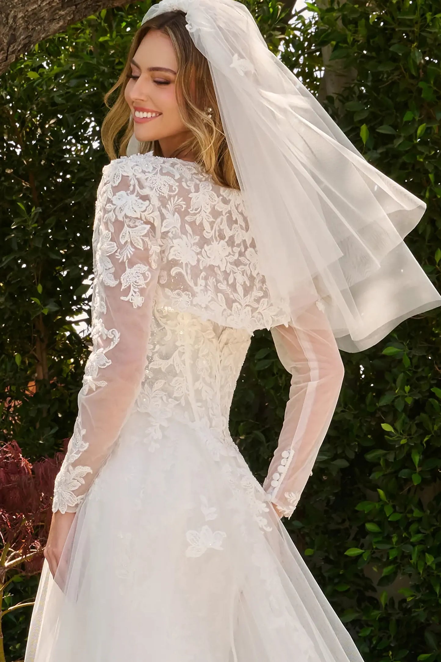 Off-white wedding dress styled with bolero shrug finished with dangling bead accents and floral embroidery