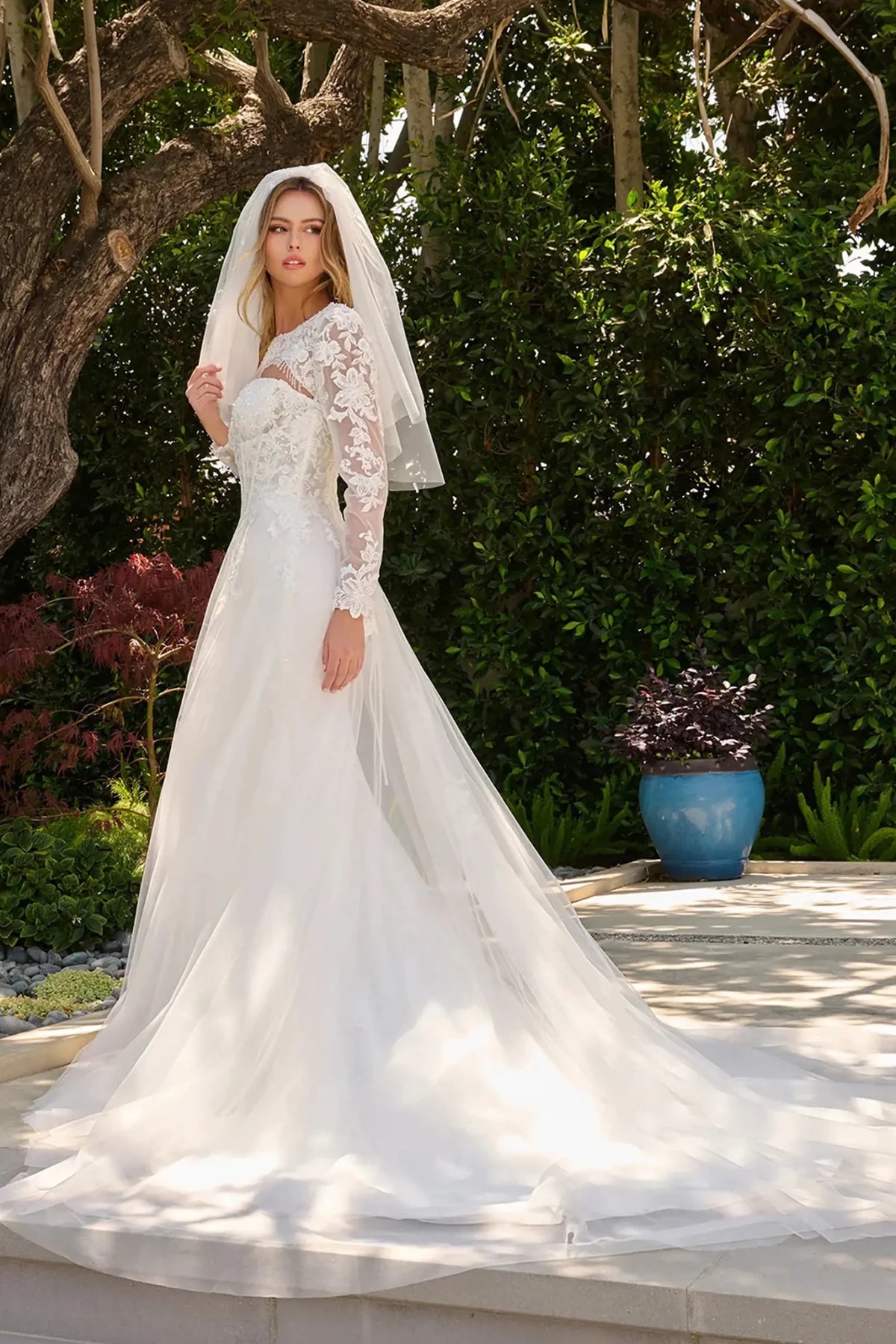 Off-white wedding dress extending into train with cohesive embroidery and beadwork with matching bolero shrug