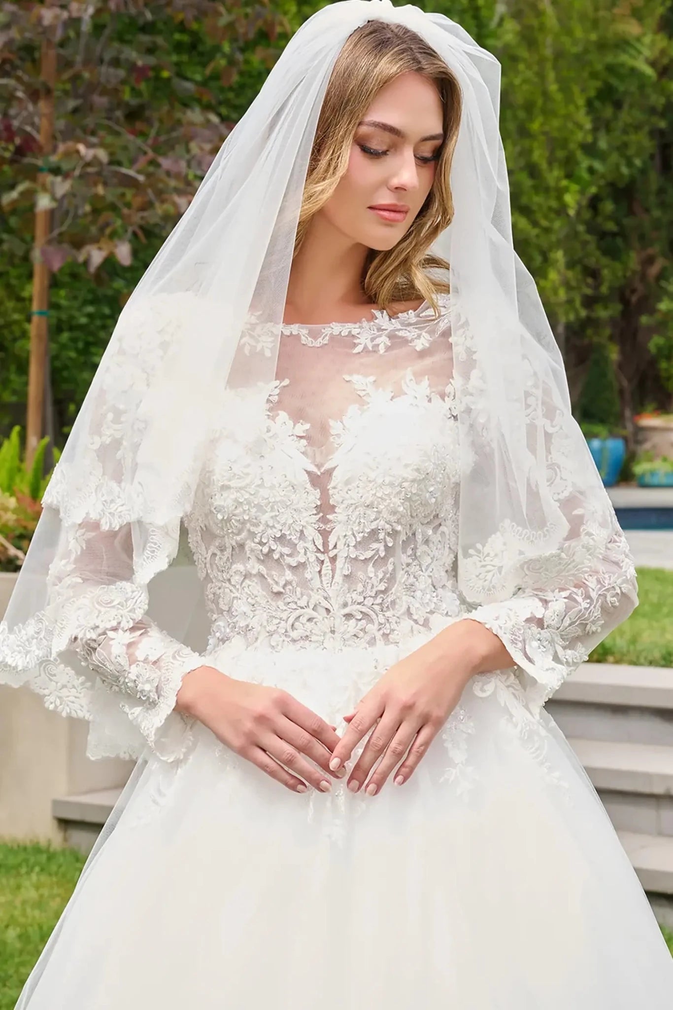 Off-white wedding dress embellished with embroidery, sequins and beads