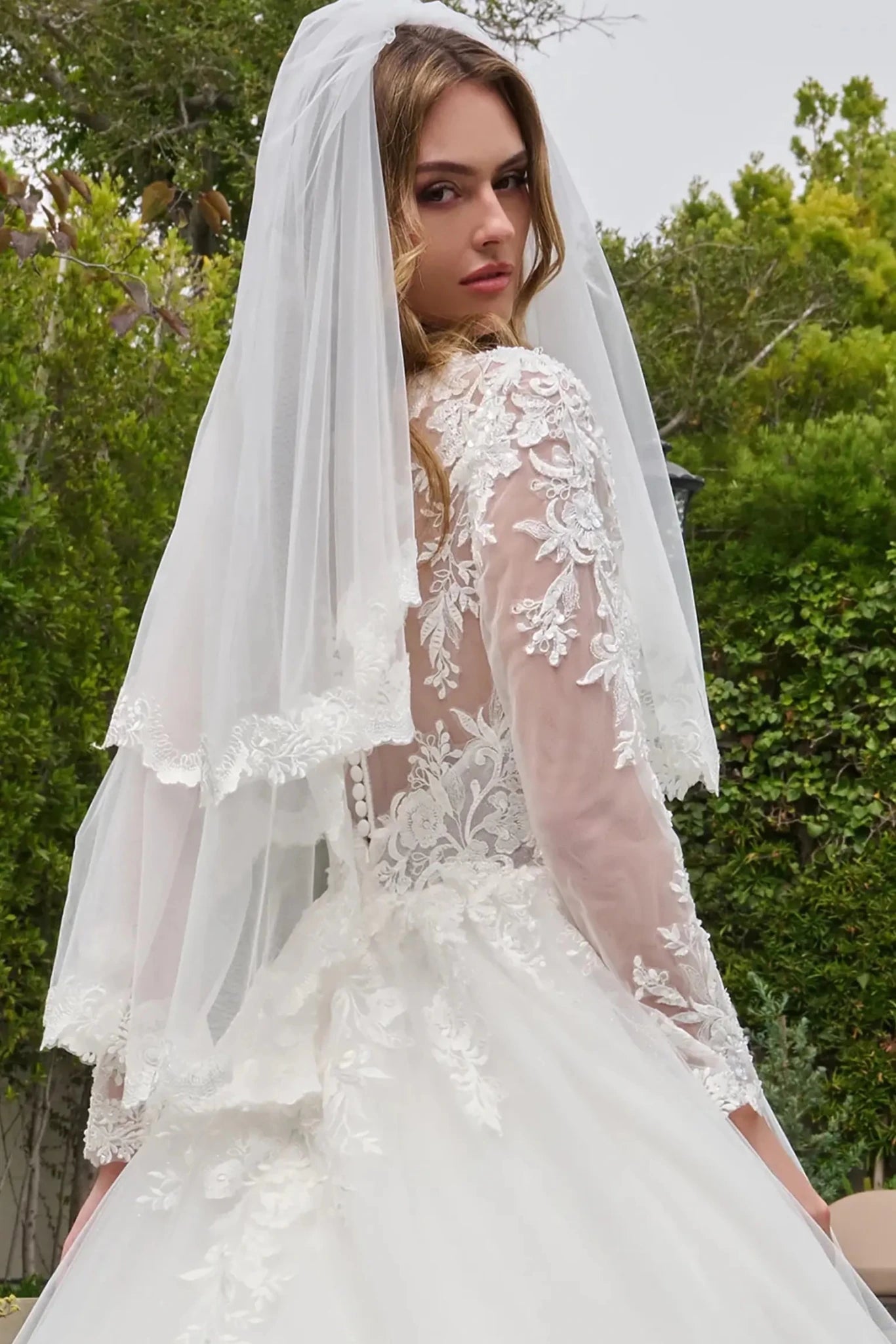 Off-white wedding dress featuring button closure at back for detail