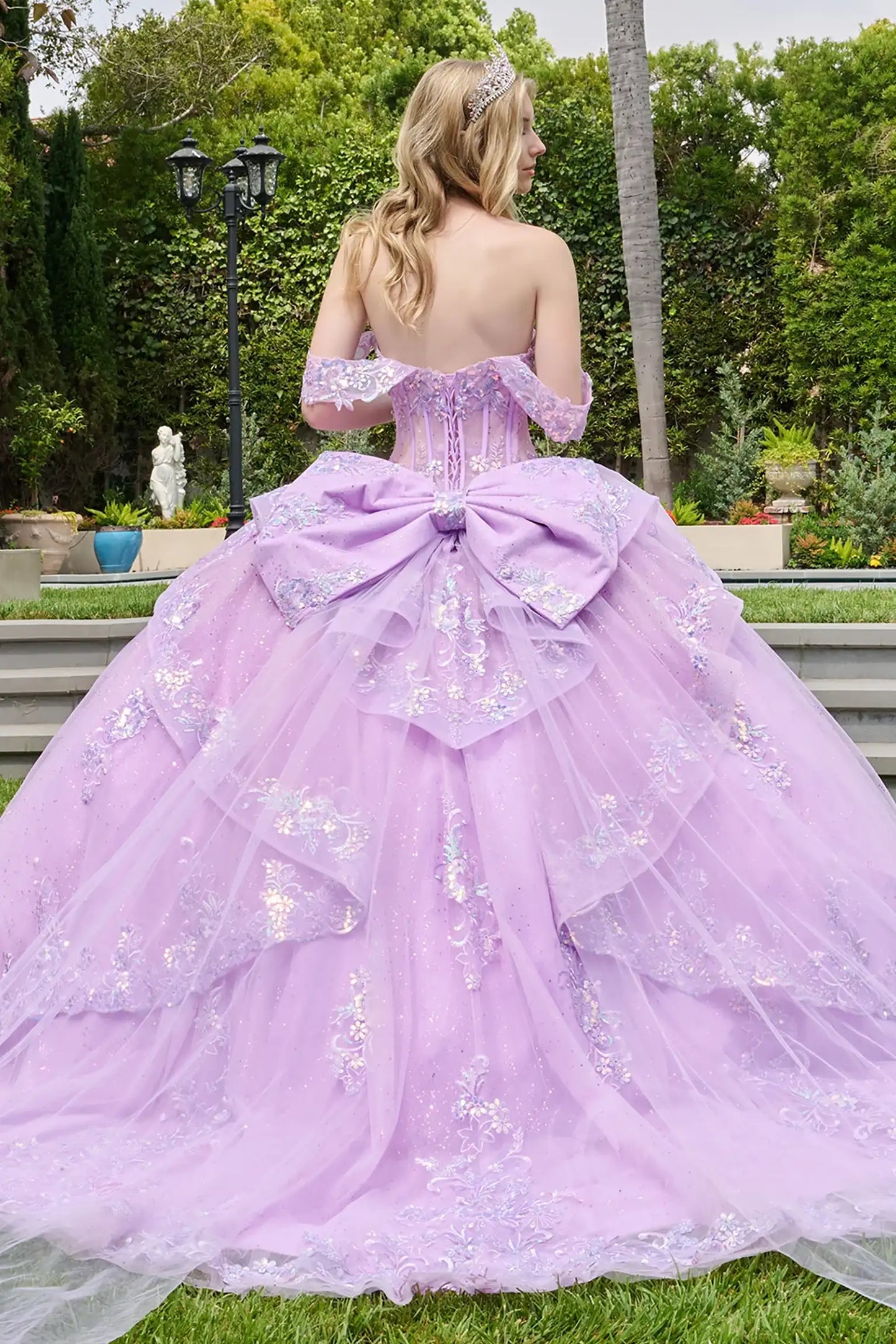 Lilac quinceañera ball gown with cascading overskirt, scallop-edge layers and voluminous tulle base