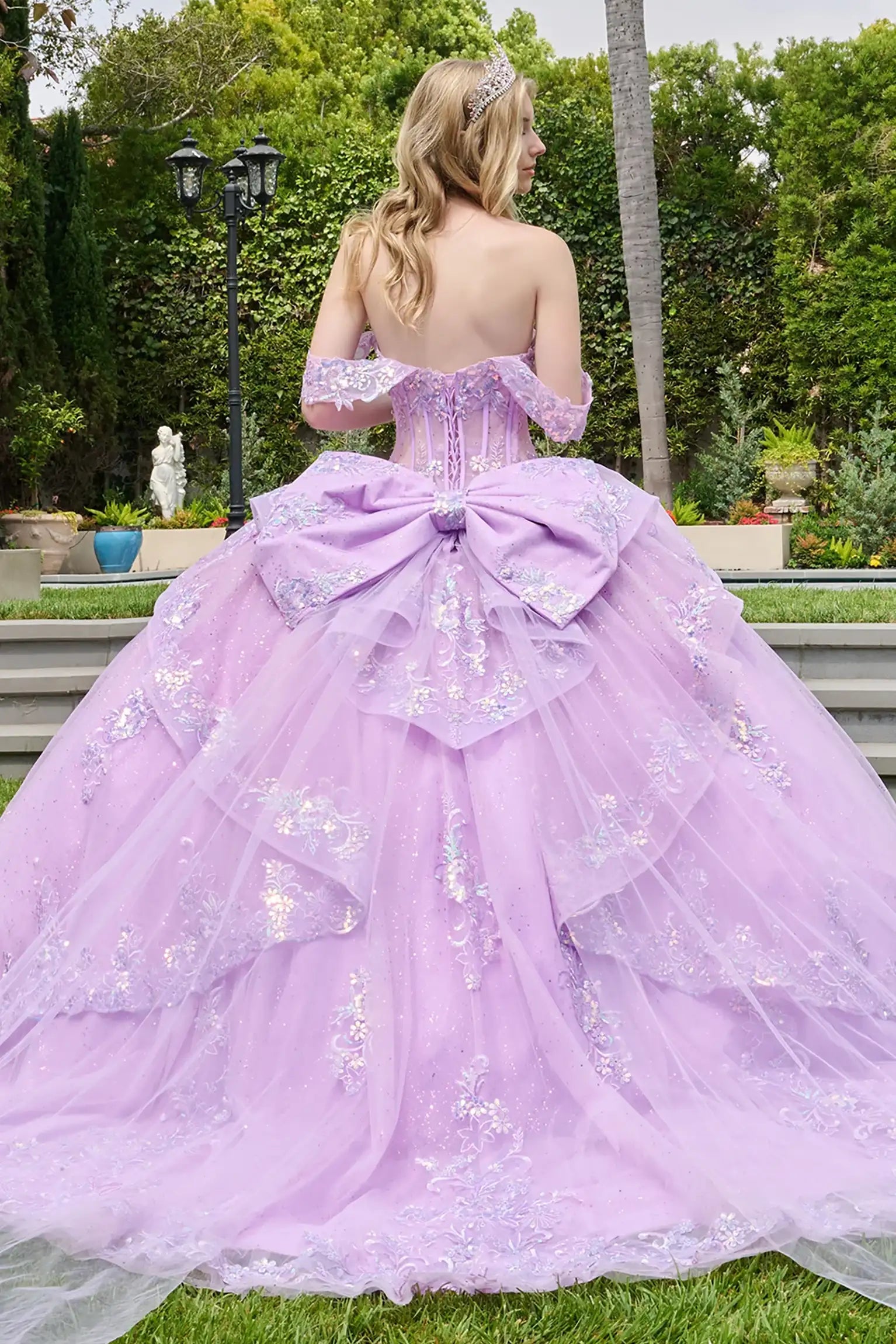 Lilac quinceañera ball gown with cascading overskirt, scallop-edge layers and voluminous tulle base