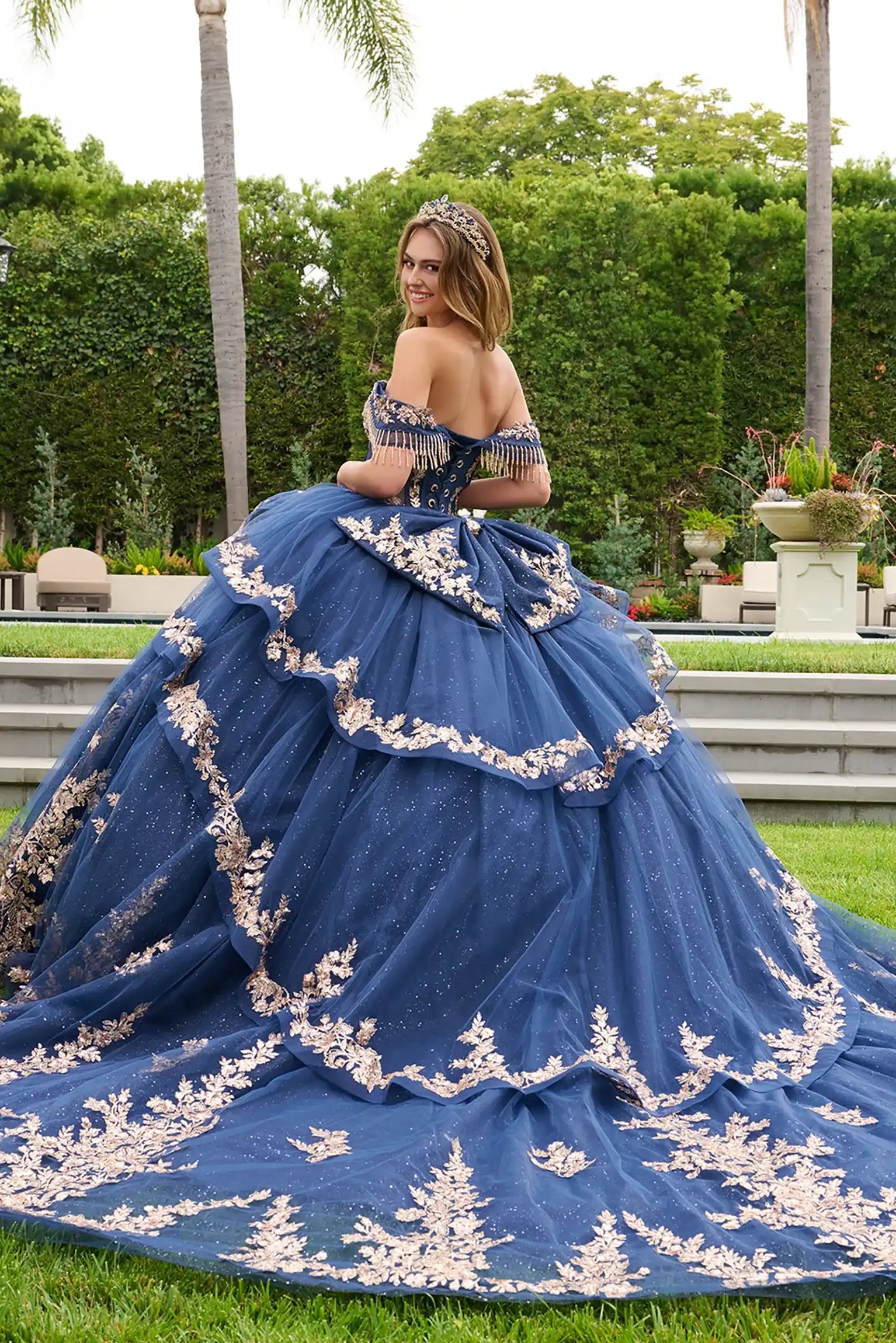 Navy quinceañera ball gown completed with sweeping train and detachable bow