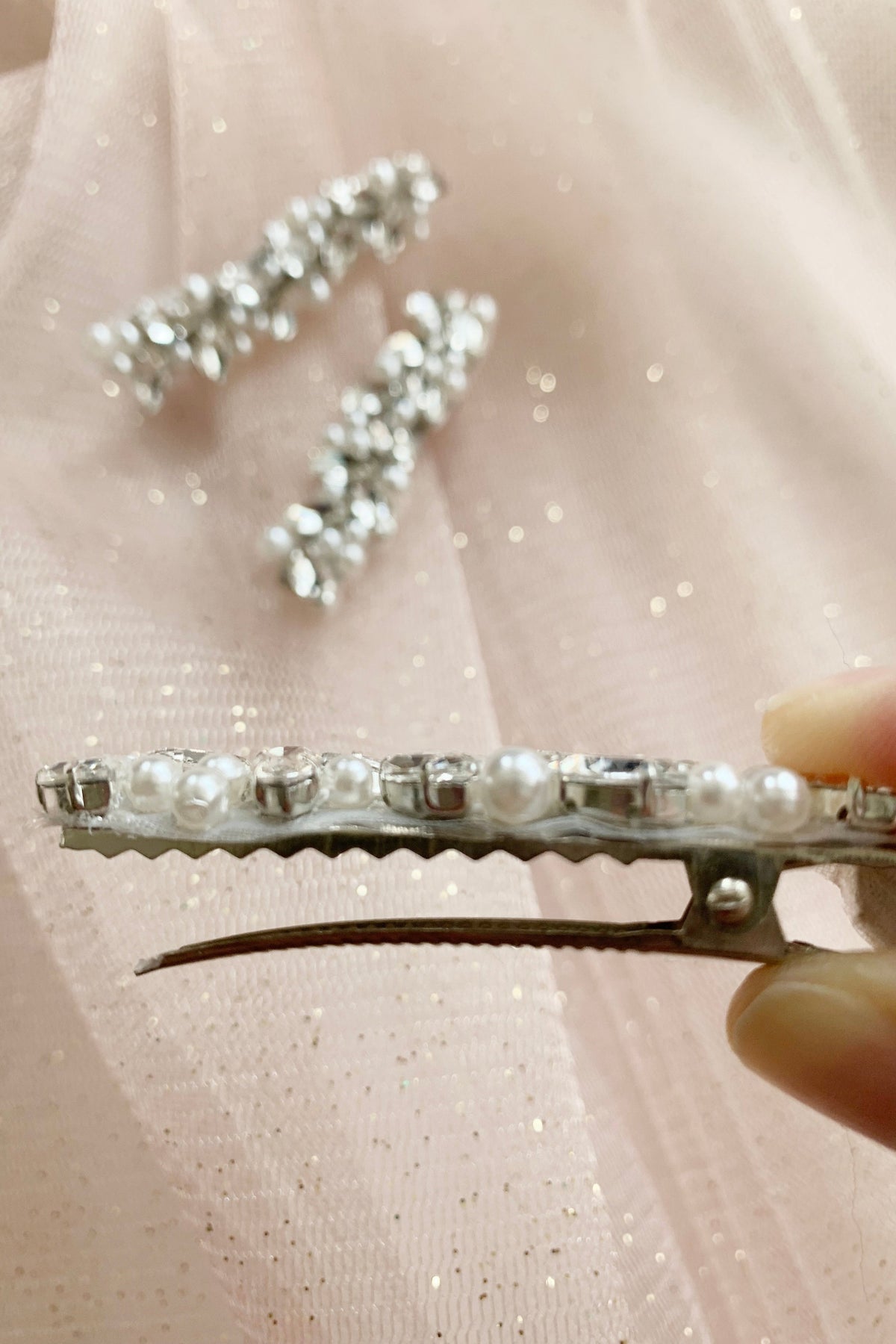 Silver pearl rhinestone flower girl hair clip, close-up.