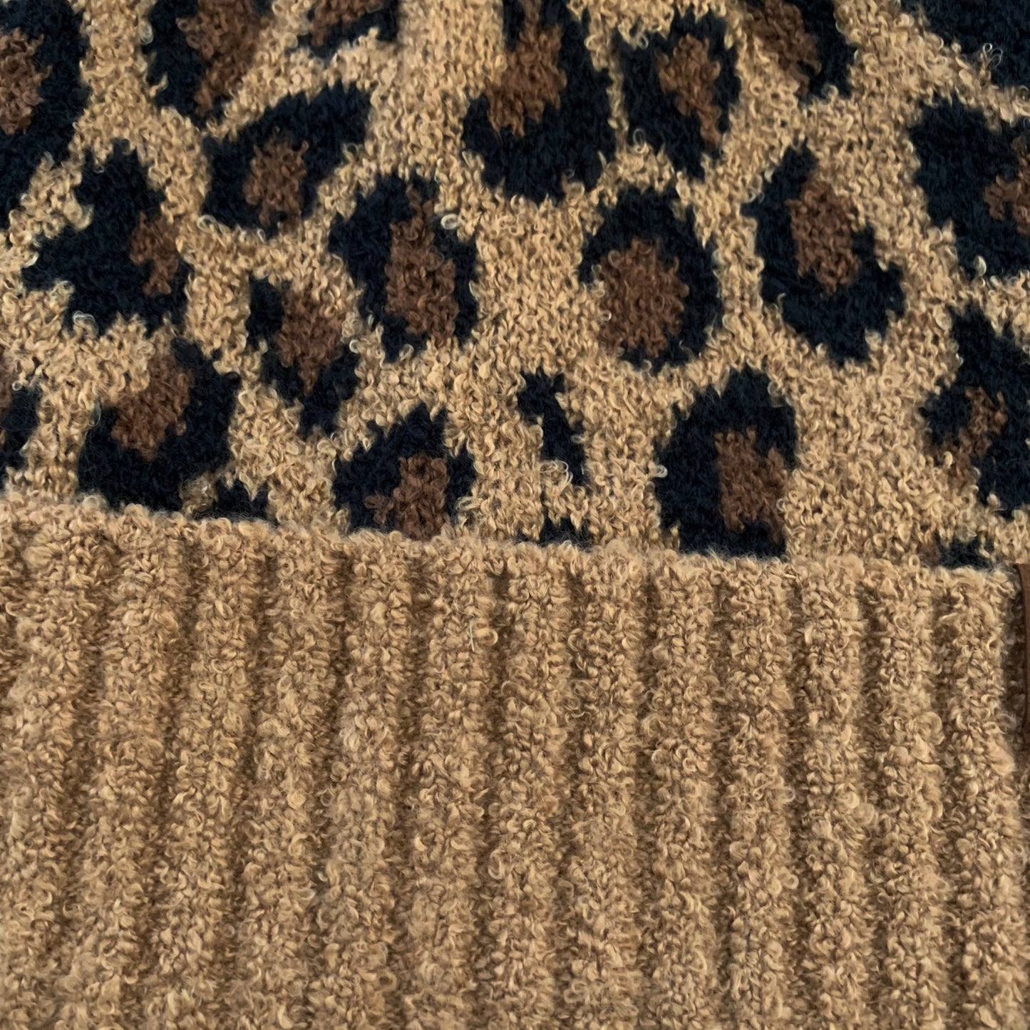Brown leopard women's winter beanie, close-up view.