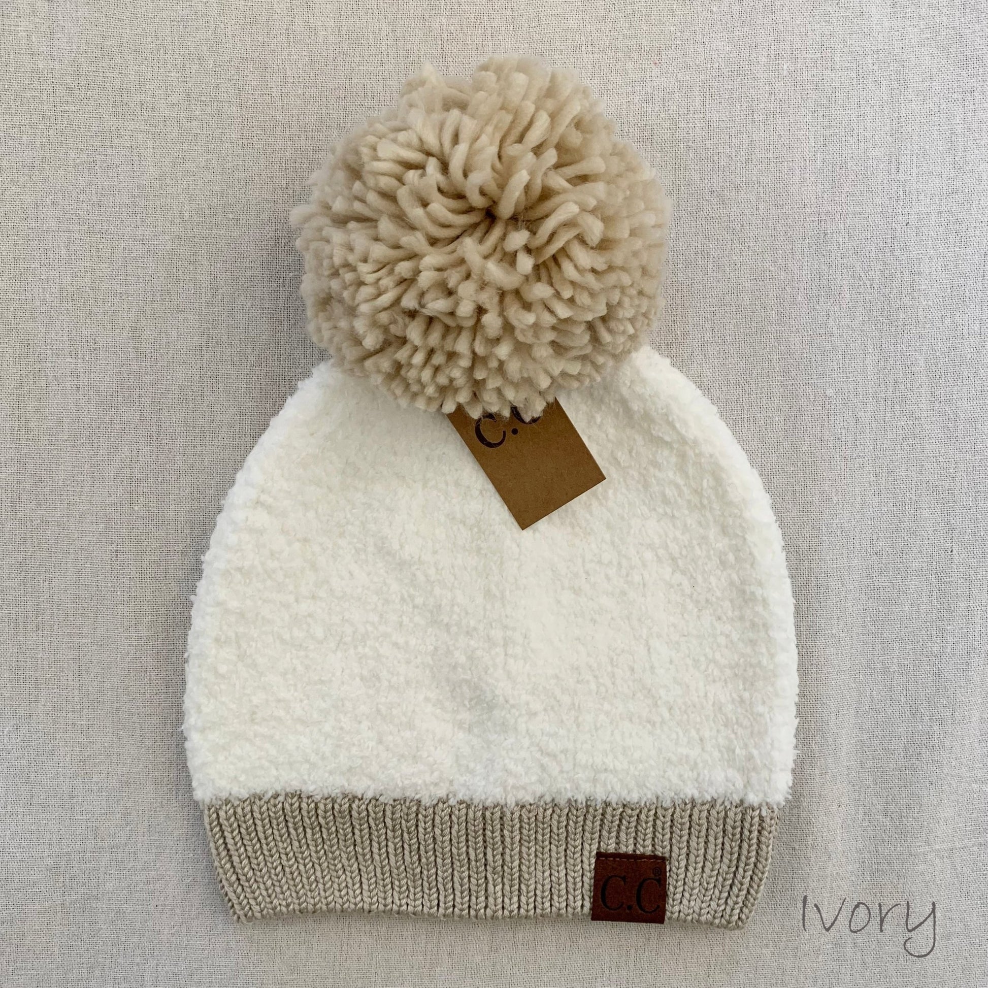 White sherpa pom-pom women's winter beanie.