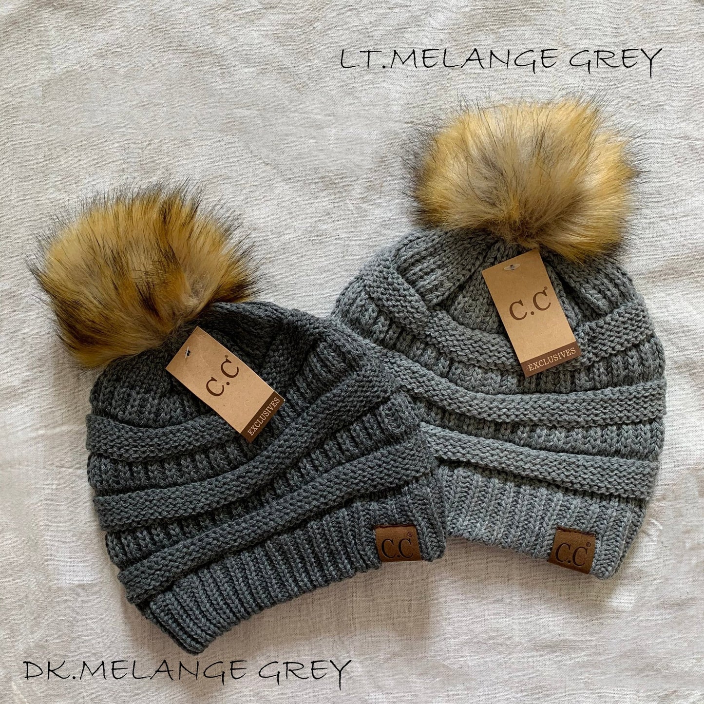 Gray pom-pom women's winter beanie.