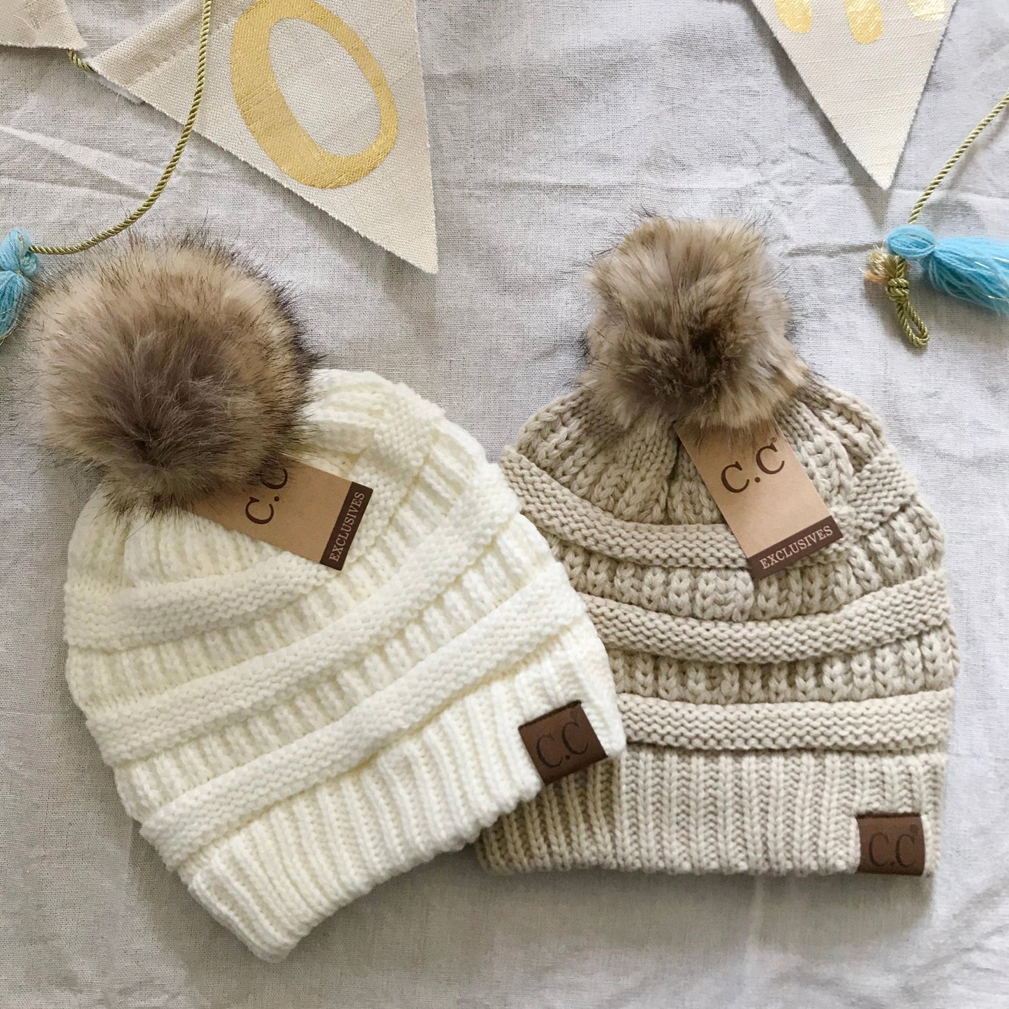 Ivory beige pom-pom women's winter beanie.