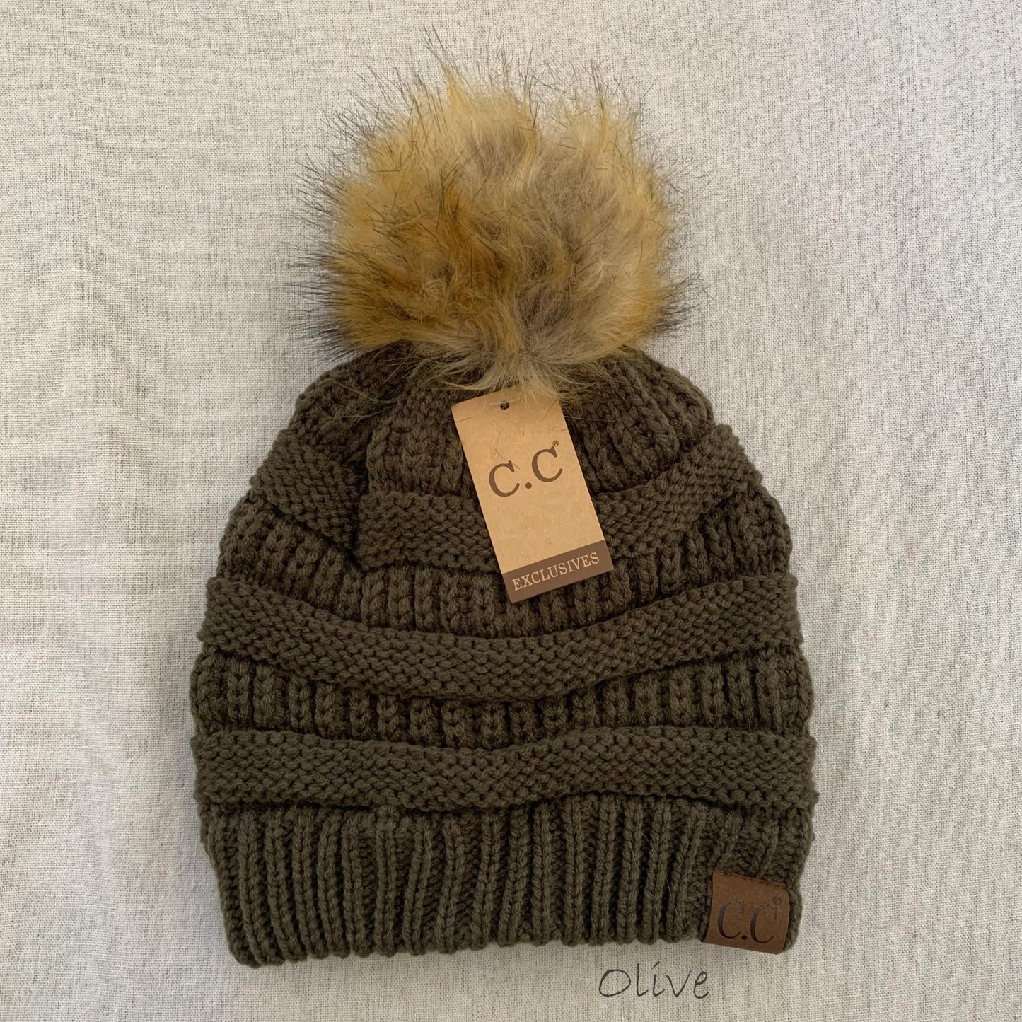 Olive pom-pom women's winter beanie.