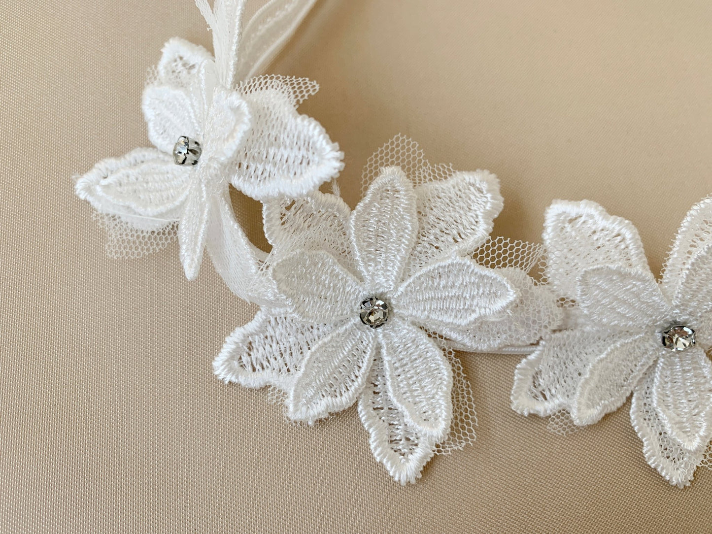Off white rhinestone floral flower girl headband, close-up, embellishment detail.