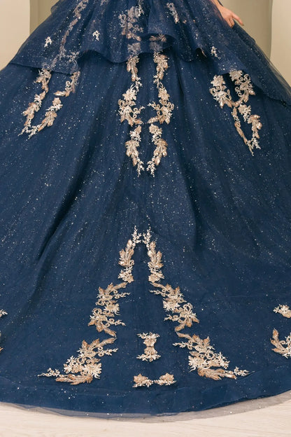 lose-up of navy quinceañera dress lower skirt with tiered shimmer tulle layers, cascading train, and glitter accents