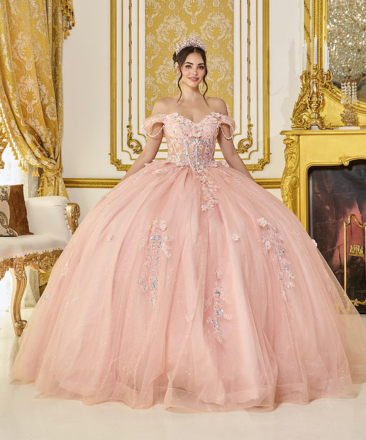 Woman in a pink off-shoulder gown with floral embellishments in an ornate room.