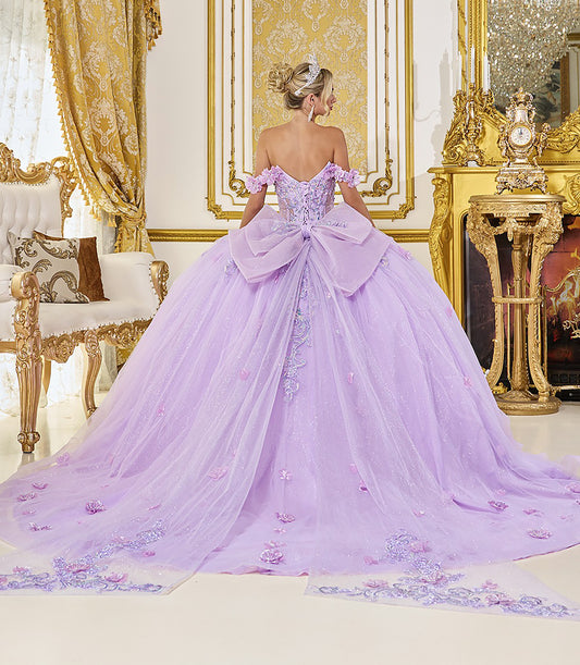 Woman in a purple gown standing in an opulent room with gold decor.