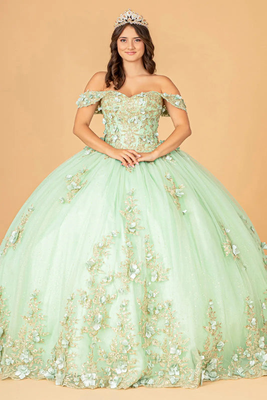 Woman wearing a sage floral off-shoulder gown with a tiara against a beige background