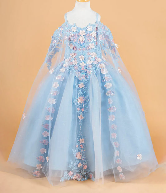 Light blue dress with floral embroidery on a mannequin against an orange background
