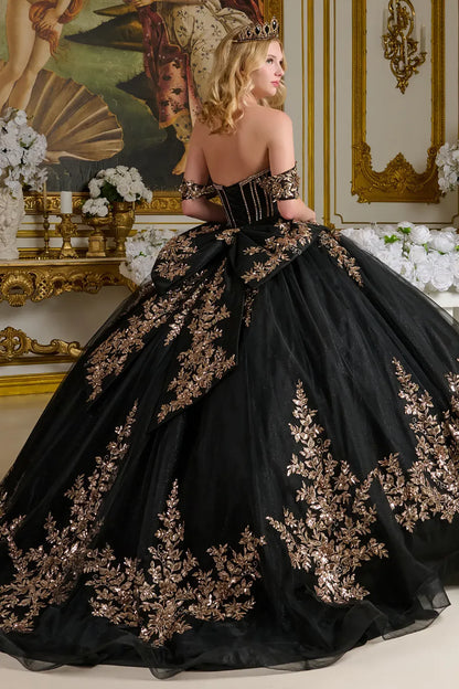 Black gown with gold embroidery in a decorated room