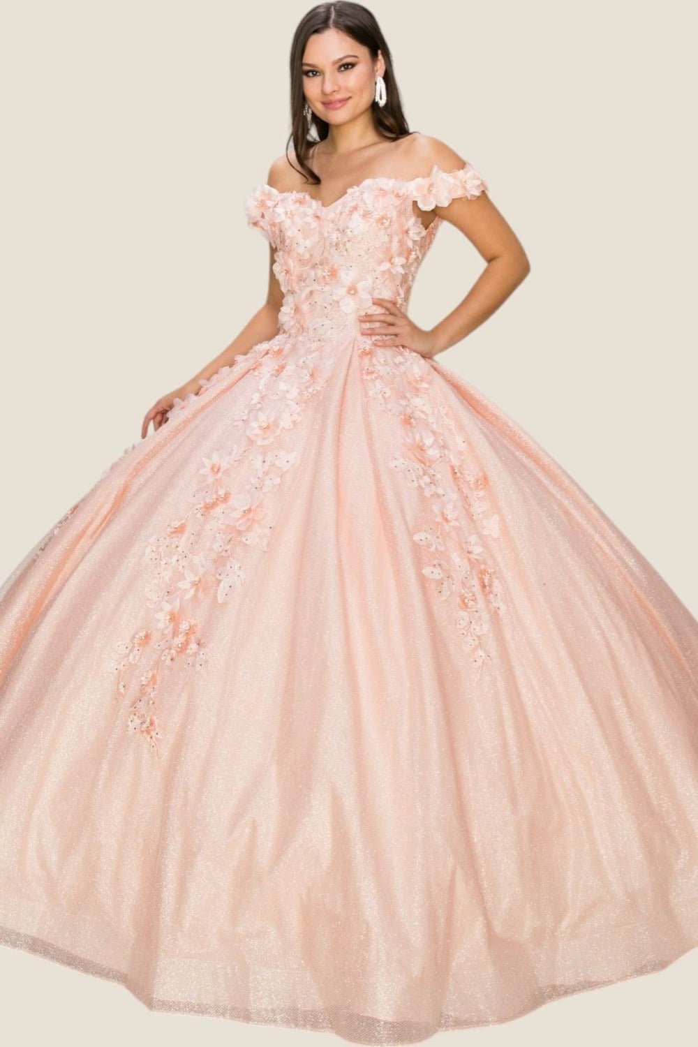 Woman wearing a pink off-shoulder gown with floral details on a light background