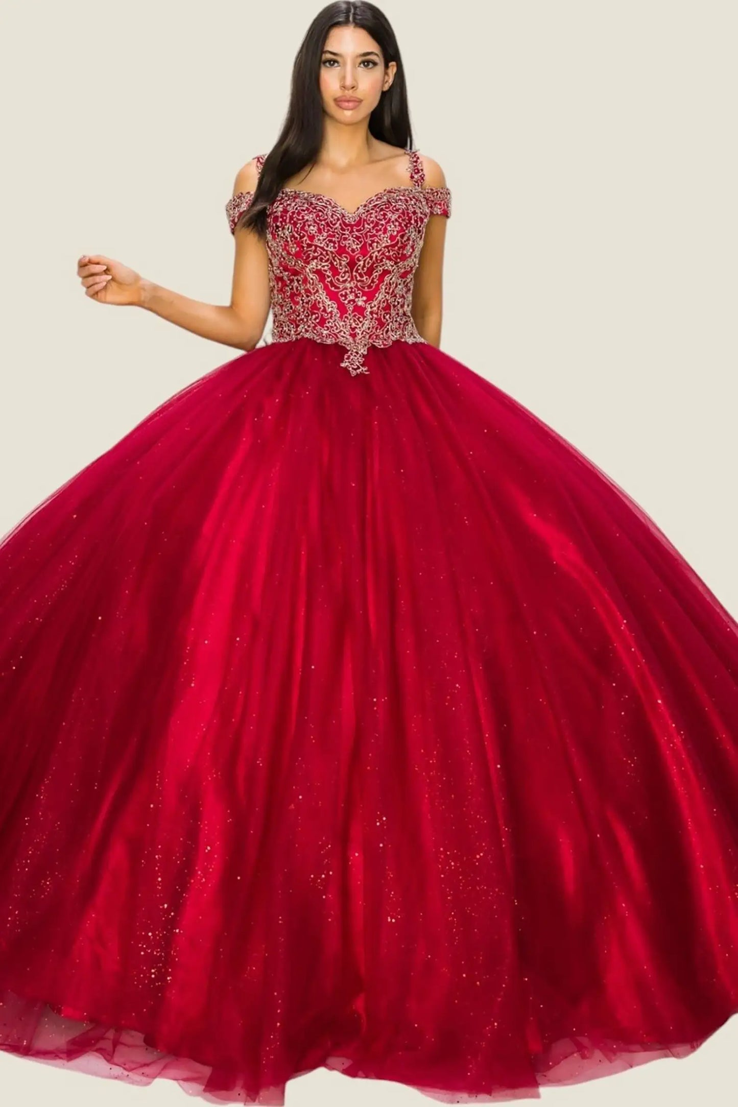 Red ball gown with intricate top design on a plain background