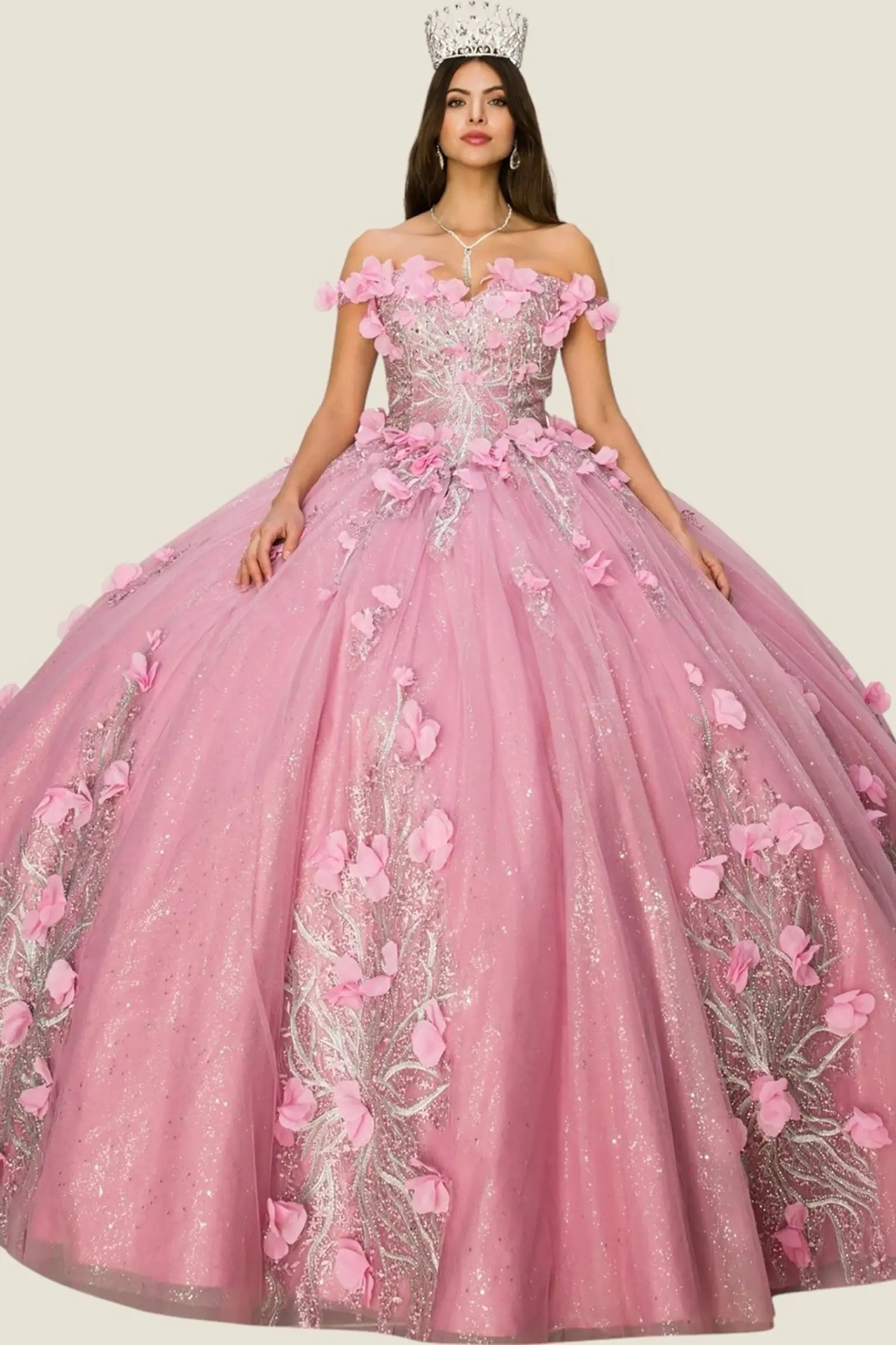 Pink quinceanera dress with floral details on a plain background