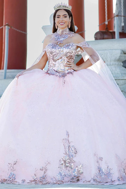 Woman in a pink and pink-silver sequin quinceañera dress with a tiara, standing outdoors.