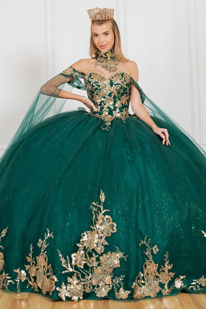 Woman wearing a green and gold ball gown with floral embroidery.