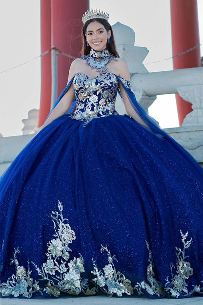Woman in a blue gown with floral embroidery standing in front of a traditional Japanese gate.
