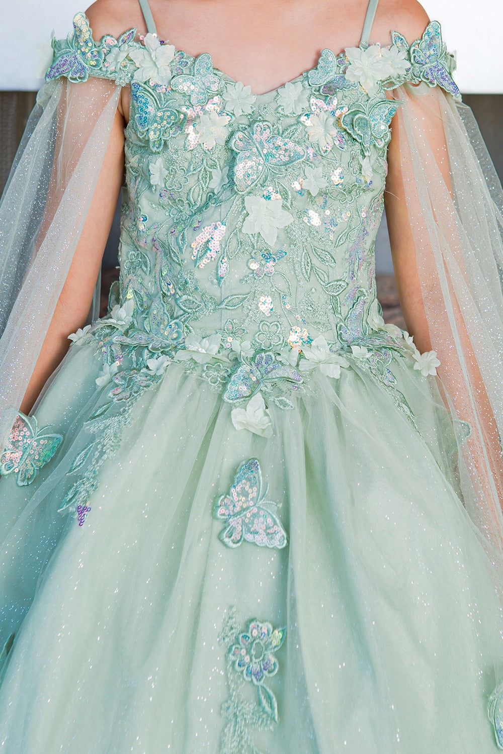 Mint green evening gown with floral and butterfly embellishments