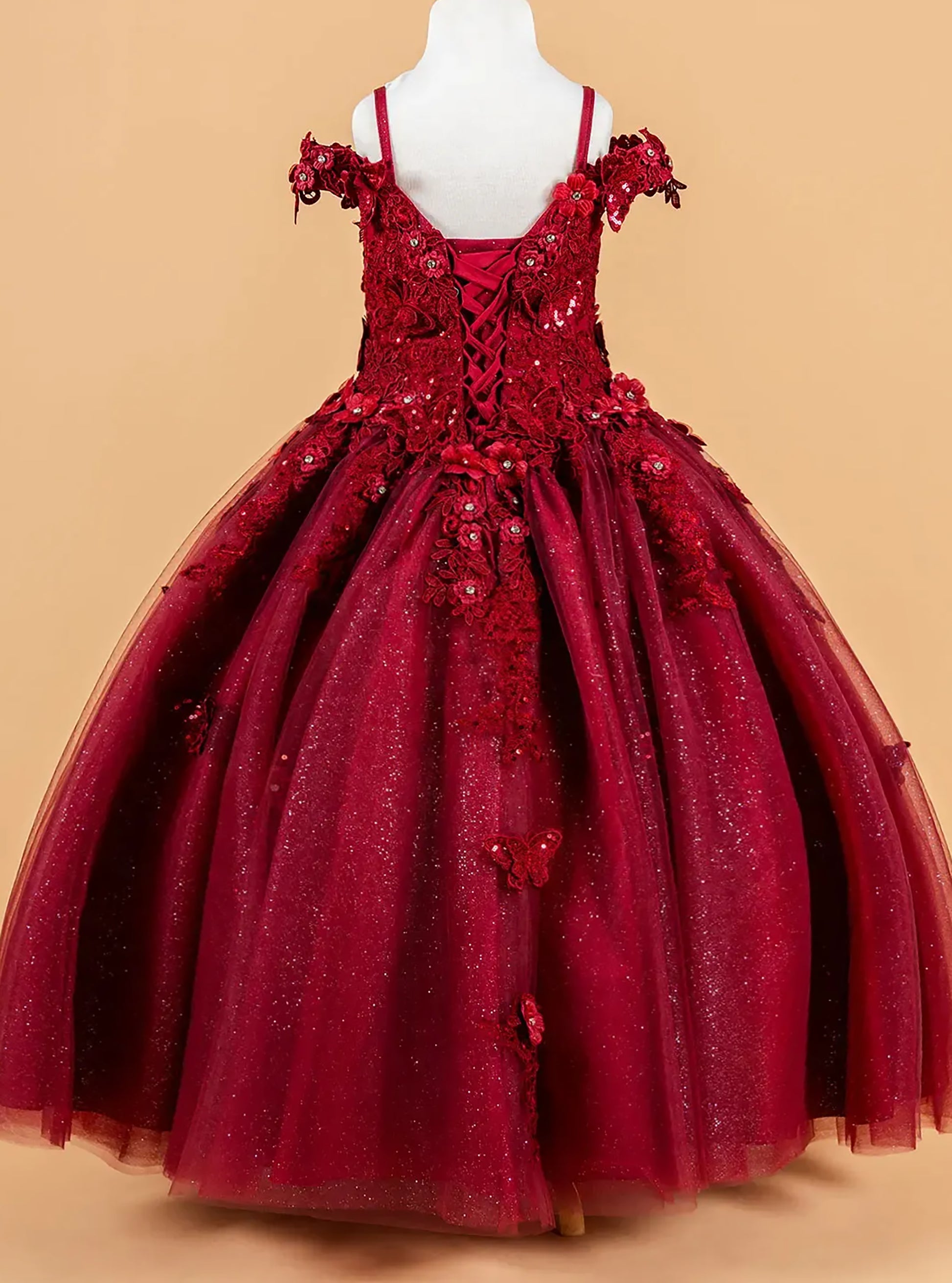 Red ball gown with floral details on a beige background