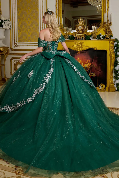 Green quince gown with floral details in a decorated room.