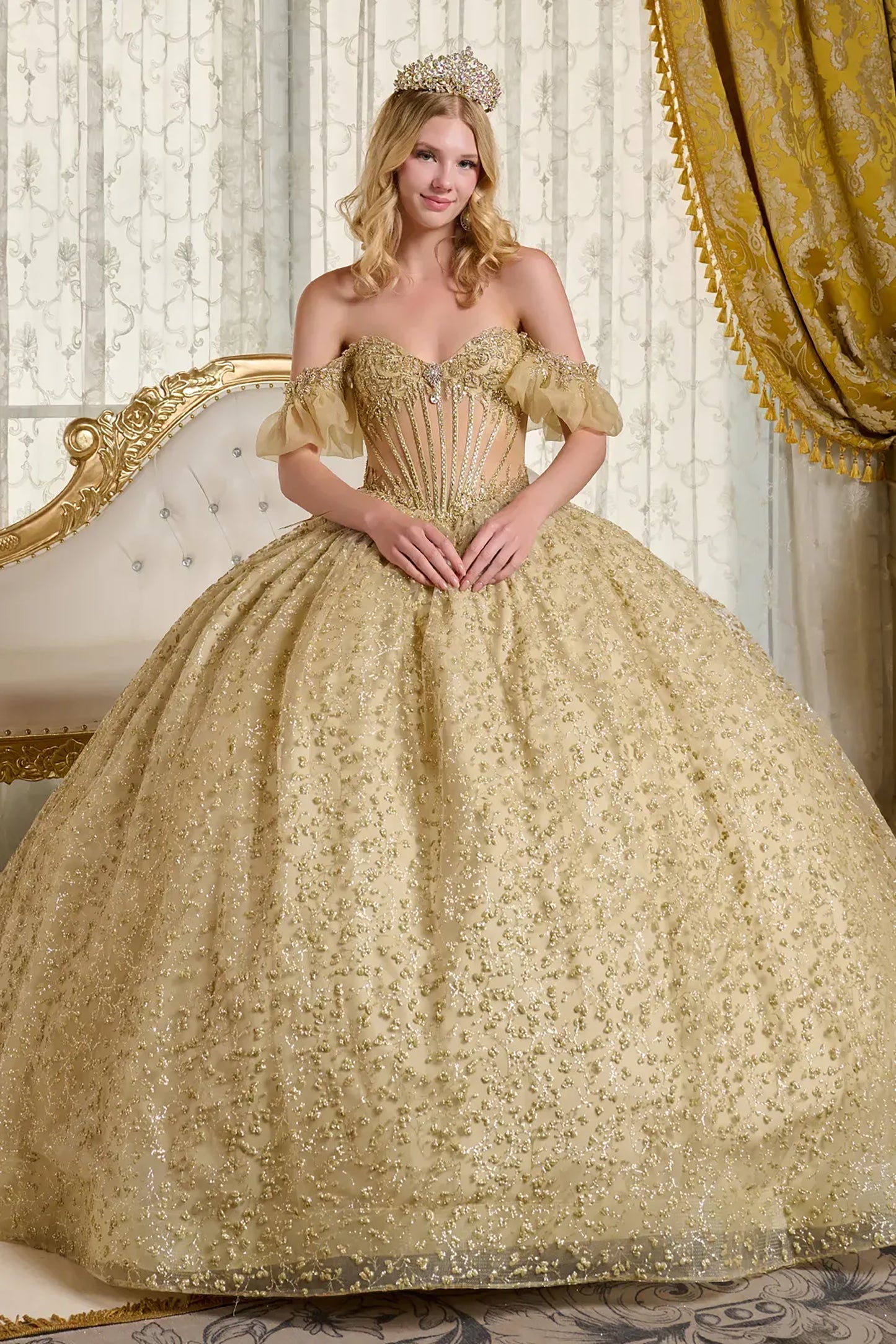 Woman in a gold gown with a tiara in an elegant room.