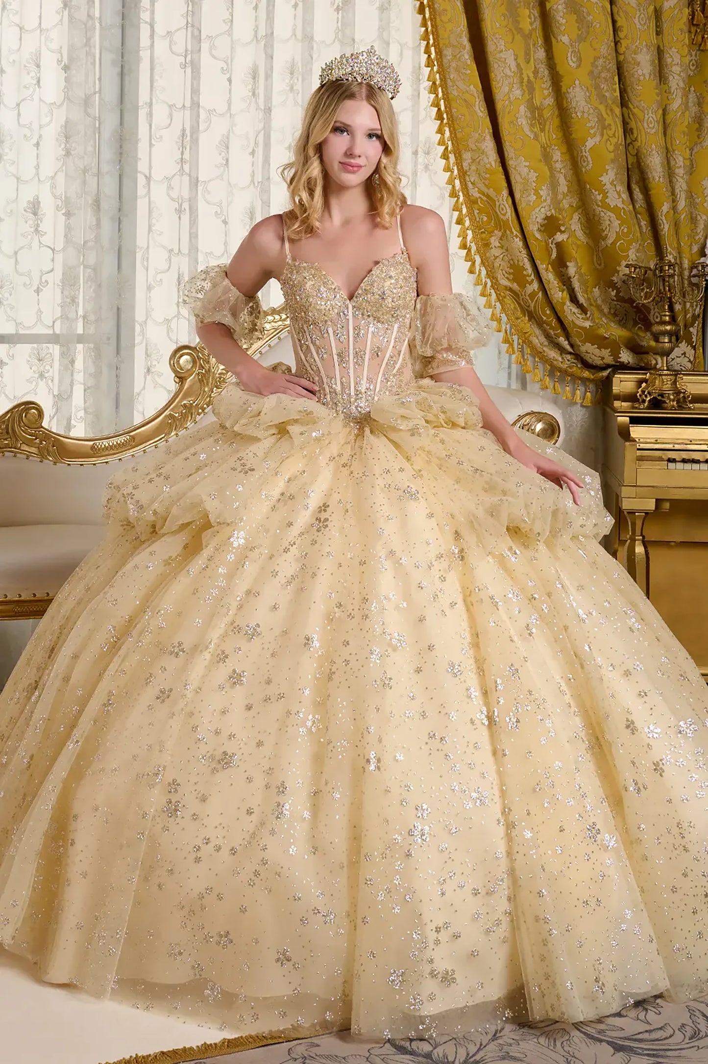 Woman in a gold quince ball gown with intricate details in a opulent room.
