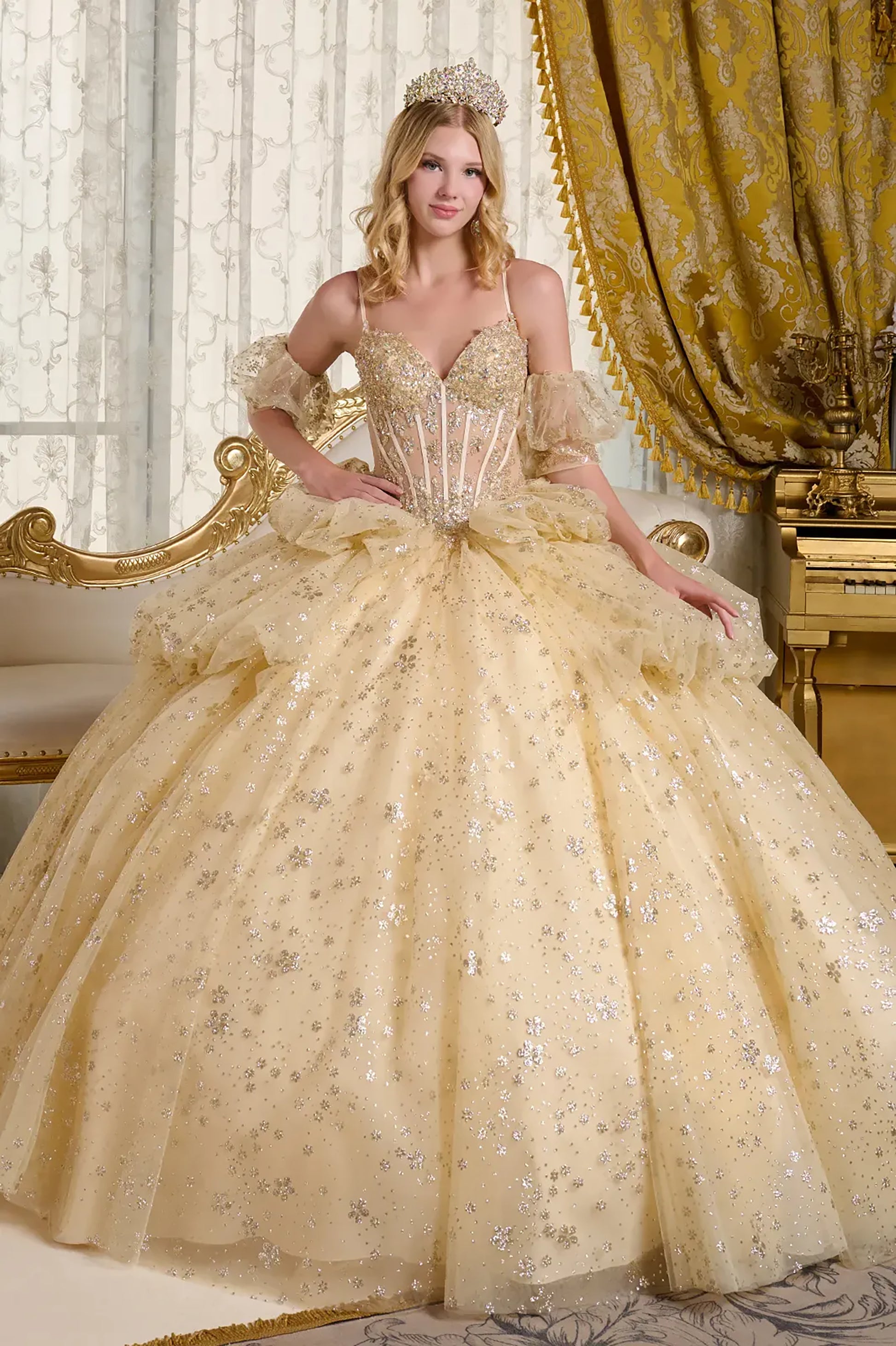 Woman in a gold quince ball gown with intricate details in a opulent room.