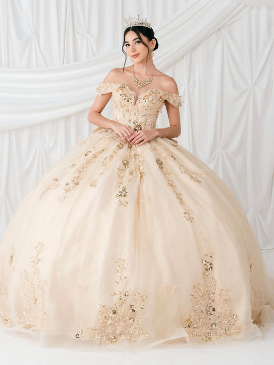 Woman in a champagne off-shoulder gown with floral details against a white background