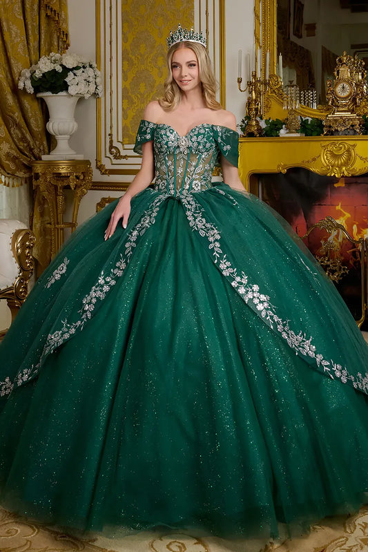 Woman in a green gown with floral details in an ornate room.