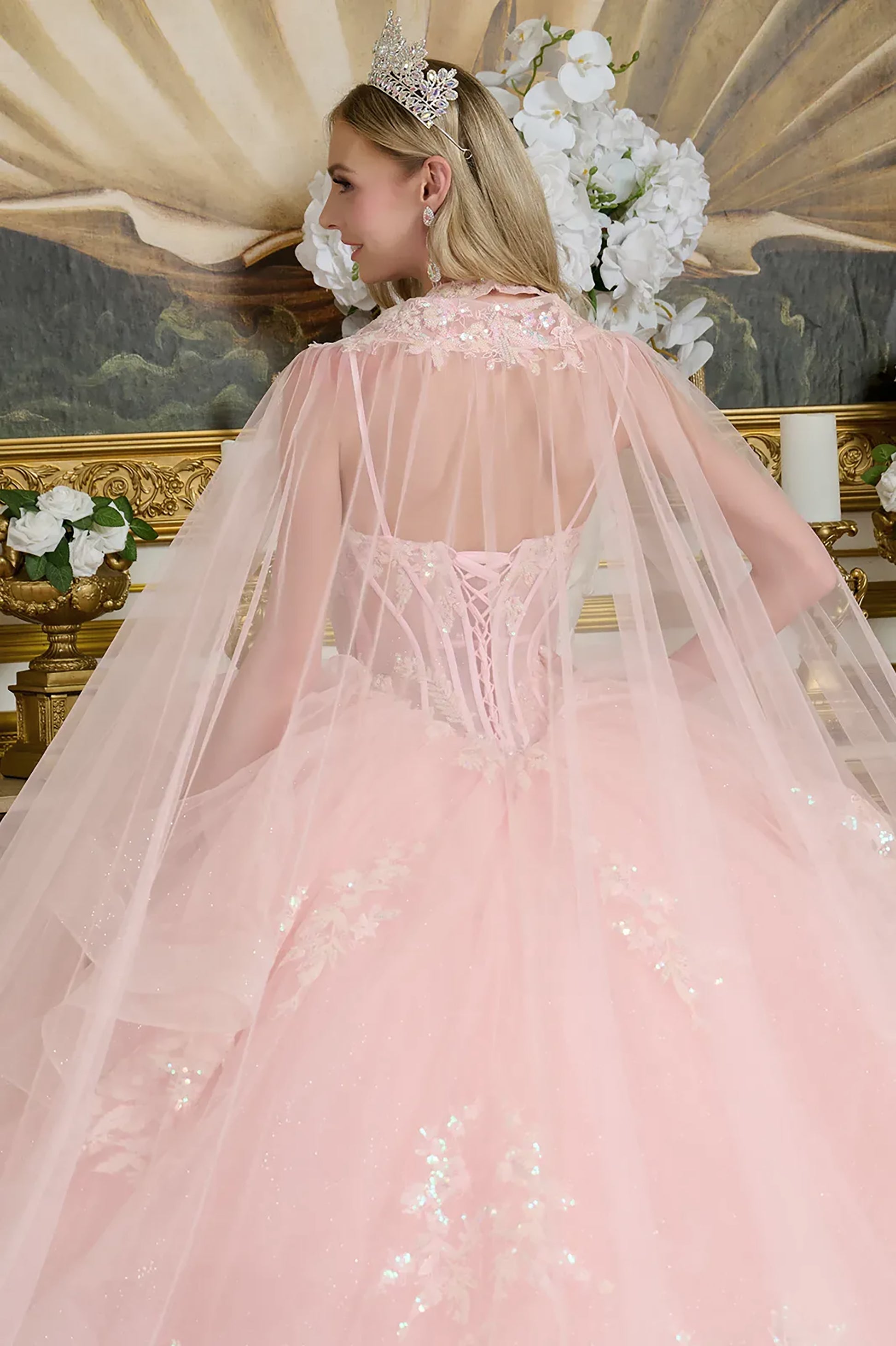 Pink gown with floral details in an elegant indoor setting