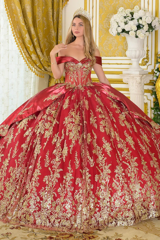 Woman wearing a burgundy and gold ball gown in an elegant interior setting.