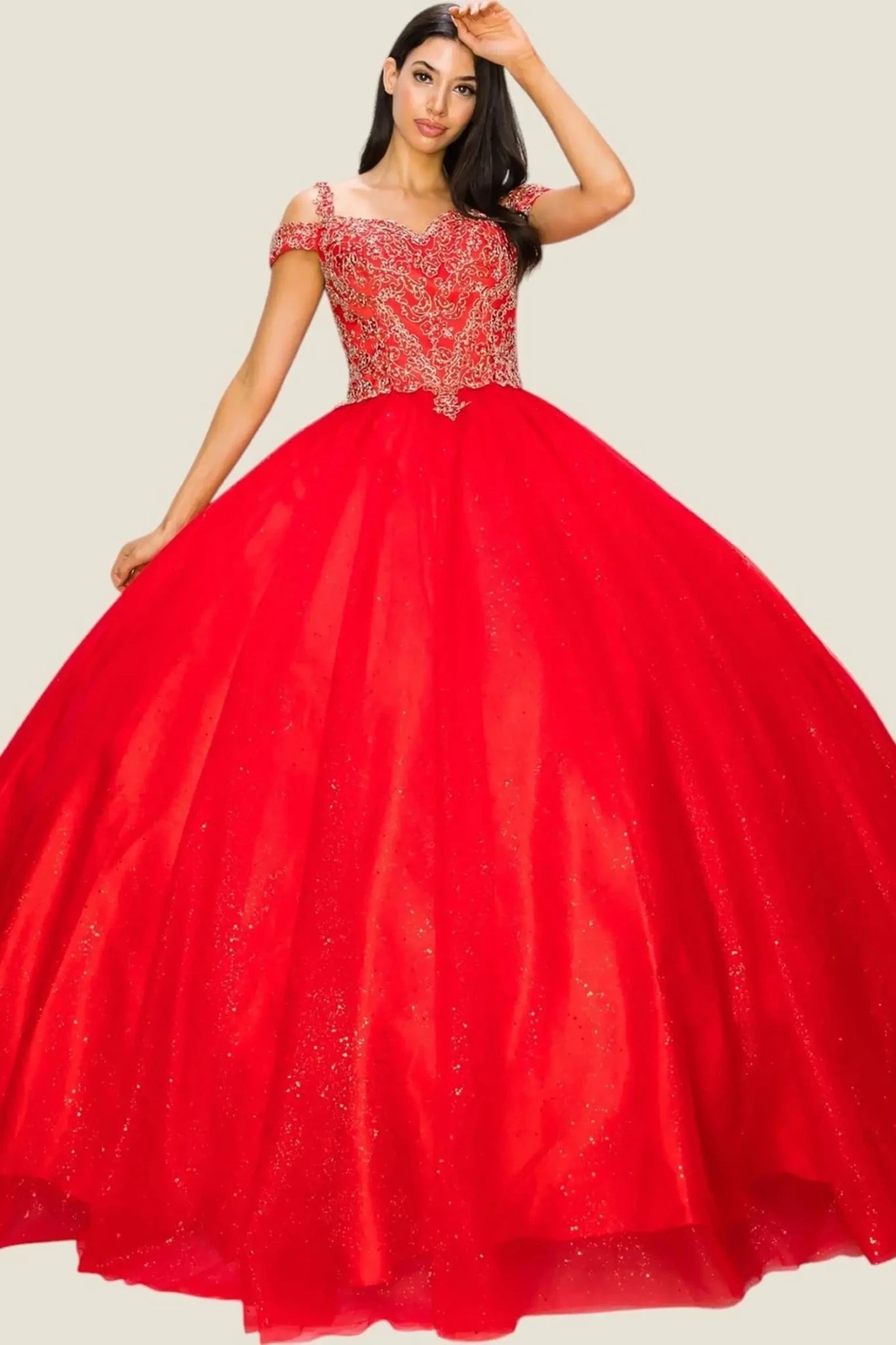 Red ball gown with intricate top design on a plain background