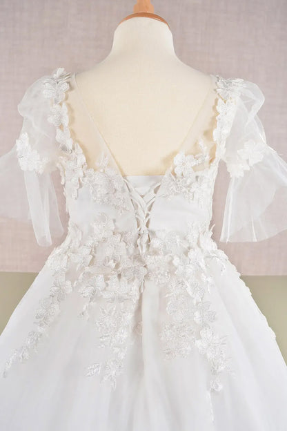 White floral dress on a mannequin against a light background