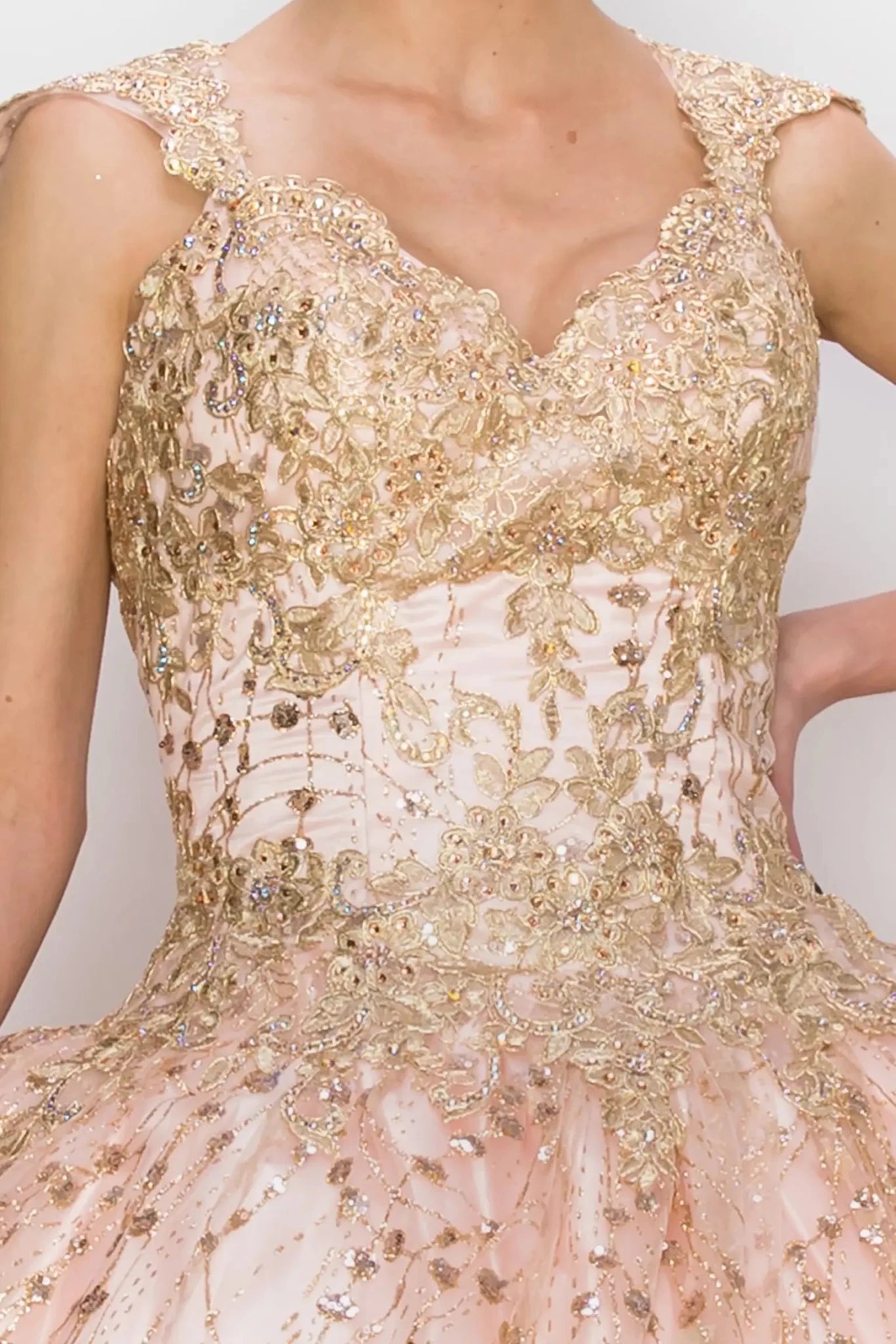 Gold and pink embroidered dress with a plain background