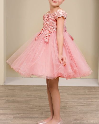 dusty rose floral dress worn by a child on a wooden floor with a beige wall background