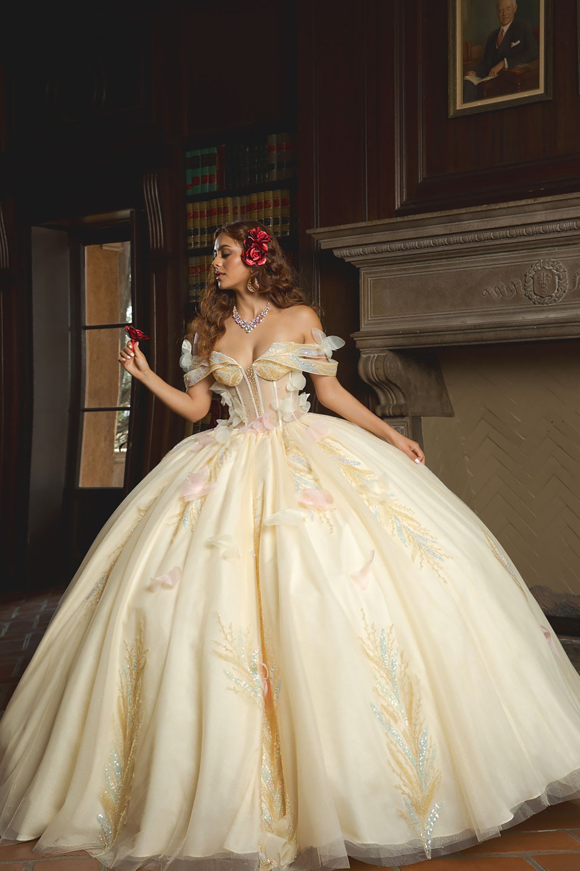 Woman in a white ball gown with floral decorations in an elegant interior setting.