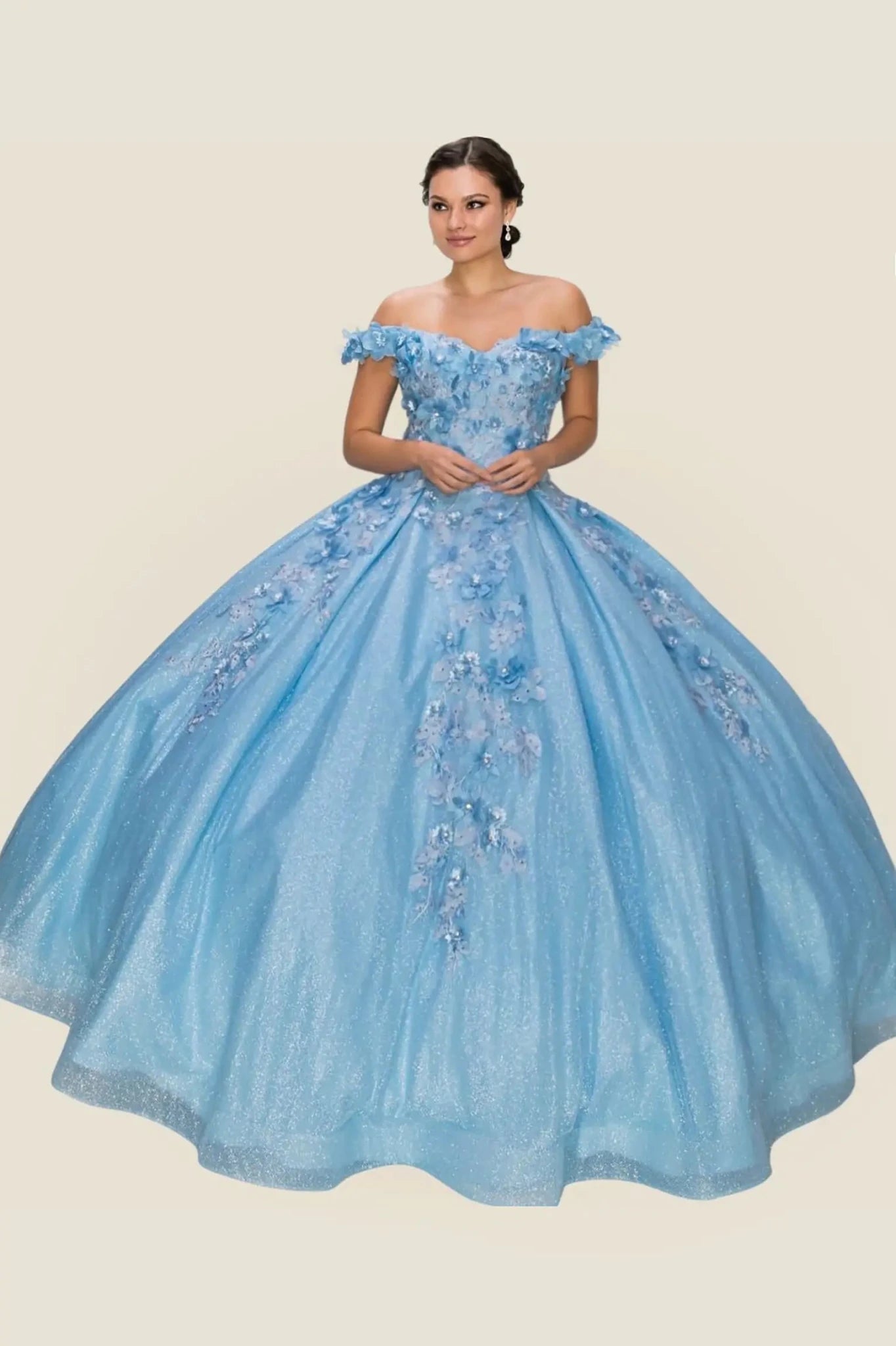 Woman wearing a light blue off-shoulder gown with floral embroidery on a beige background